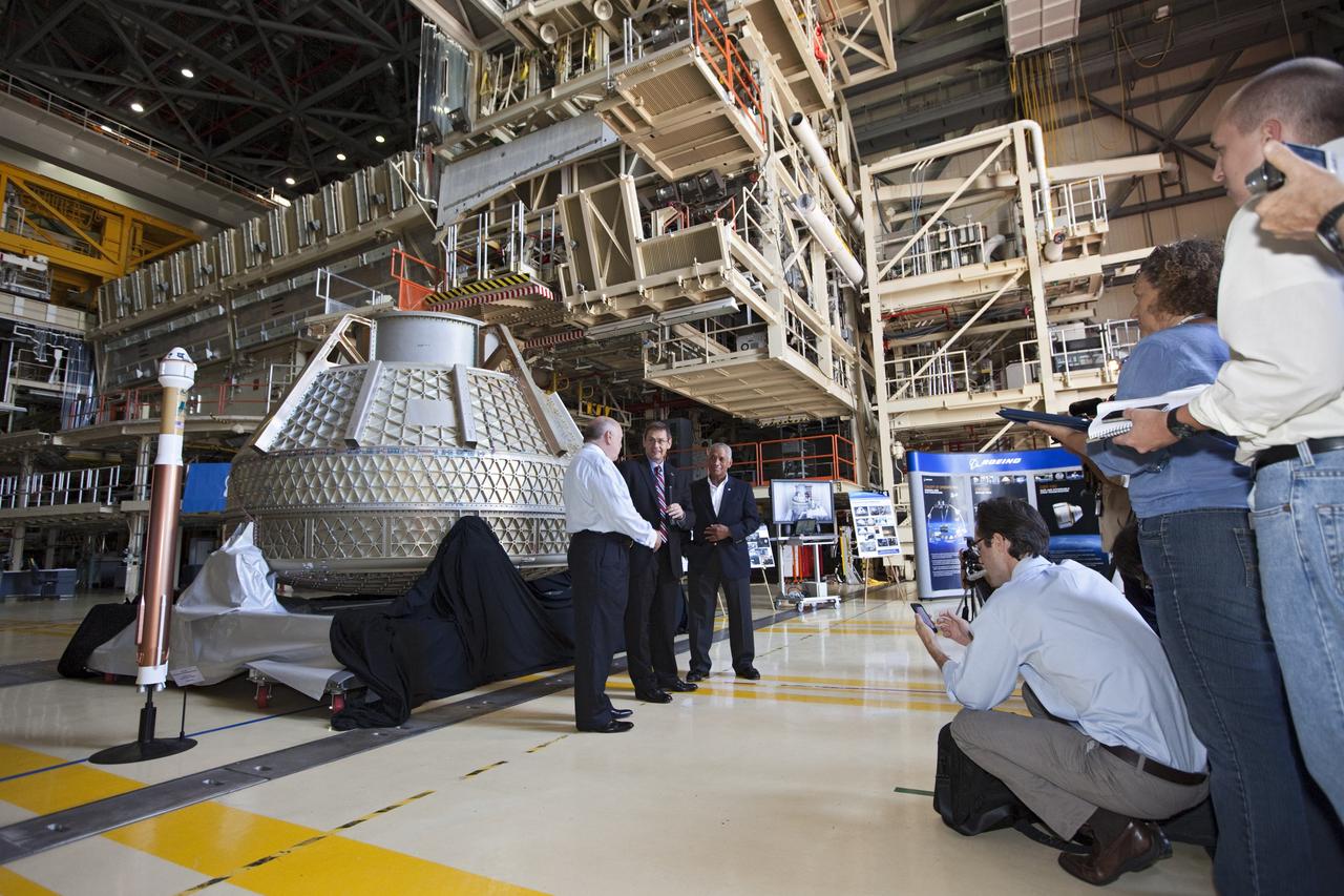 CAPE CANAVERAL, Fla. – Space Florida President Frank DiBello, NASA Administrator Charlie Bolden, and Boeing's Vice President and General Manager of Space Exploration John Elbon address the media inside Orbiter Processing Facility-3, or OPF-3, at NASA's Kennedy Space Center in Florida. Bolden took a few dozen media on a road show tour of the center and adjacent Cape Canaveral Air Force Station to show the progress being made for future government and commercial space endeavors that will begin from Florida's Space Coast. Boeing is leasing OPF-3 through an agreement with Space Florida for the manufacturing and assembly of its CST-100 spacecraft, which is under development in collaboration with NASA's Commercial Crew Program. During his tour, Bolden announced that Space Exploration Technologies, or SpaceX, has completed its Space Act Agreement with NASA for Commercial Orbital Transportation Services. SpaceX is scheduled to launch the first of its 12 contracted cargo flights to the space station from Cape Canaveral this October, under NASA’s Commercial Resupply Services Program. Bolden also announced NASA partner Sierra Nevada Corp. has conducted its first milestone under the agency’s recently announced Commercial Crew Integrated Capability CCiCap initiative. The milestone, a program implementation plan review, marks an important first step in Sierra Nevada’s efforts to develop a crew transportation system with its Dream Chaser spacecraft. Through NASA’s commercial space initiatives and programs, the agency is providing investments to stimulate the American commercial space industry. Photo credit: NASA/Kim Shiflett