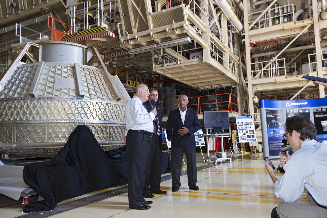 CAPE CANAVERAL, Fla. – Space Florida President Frank DiBello, NASA Administrator Charlie Bolden, and Boeing's Vice President and General Manager of Space Exploration John Elbon address the media inside Orbiter Processing Facility-3, or OPF-3, at NASA's Kennedy Space Center in Florida. Bolden took a few dozen media on a road show tour of the center and adjacent Cape Canaveral Air Force Station to show the progress being made for future government and commercial space endeavors that will begin from Florida's Space Coast. Boeing is leasing OPF-3 through an agreement with Space Florida for the manufacturing and assembly of its CST-100 spacecraft, which is under development in collaboration with NASA's Commercial Crew Program. During his tour, Bolden announced that Space Exploration Technologies, or SpaceX, has completed its Space Act Agreement with NASA for Commercial Orbital Transportation Services. SpaceX is scheduled to launch the first of its 12 contracted cargo flights to the space station from Cape Canaveral this October, under NASA’s Commercial Resupply Services Program. Bolden also announced NASA partner Sierra Nevada Corp. has conducted its first milestone under the agency’s recently announced Commercial Crew Integrated Capability CCiCap initiative. The milestone, a program implementation plan review, marks an important first step in Sierra Nevada’s efforts to develop a crew transportation system with its Dream Chaser spacecraft. Through NASA’s commercial space initiatives and programs, the agency is providing investments to stimulate the American commercial space industry. Photo credit: NASA/Kim Shiflett