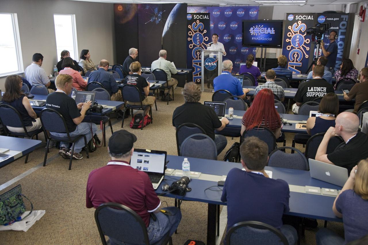 CAPE CANAVERAL, Fla. – At NASA's Kennedy Space Center in Florida, Jason Townsend of NASA's Social Media Team welcomes agency social media followers to the second day of activities revolving around NASA's Radiation Belt Storm Probes, or RBSP, mission. The probes are set to launch aboard a United Launch Alliance, or ULA, Atlas V rocket from nearby Cape Canaveral Air Force Station. About 40 followers were selected to participate in RBSP's prelaunch and launch activities and share them with their own fan base. The RBSP mission will help us understand the sun’s influence on Earth and near-Earth space by studying the Earth’s radiation belts on various scales of space and time. RBSP will begin its mission of exploration of Earth’s Van Allen radiation belts and the extremes of space weather. For more information, visit http://www.nasa.gov/rbsp. Photo credit: NASA/Frankie Martin