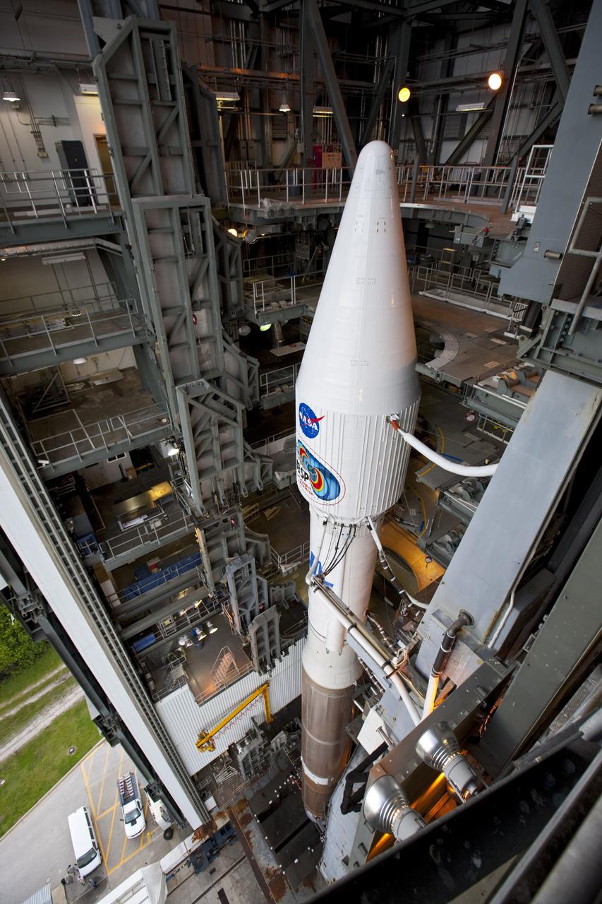 CAPE CANAVERAL, Fla. – A view from above shows the United Launch Alliance Atlas V rocket, carrying NASA’s twin Radiation Belt Storm Probes, or RBSP, inside the Vertical Integration Facility after rolling back from Space Launch Complex 41 at Cape Canaveral Air Force Station in Florida. The rocket and spacecraft will be secured and protected from inclement weather due to Tropical Storm Isaac.     RBSP will explore changes in Earth's space environment caused by the sun -- known as "space weather" -- that can disable satellites, create power-grid failures and disrupt GPS service. The mission also will provide data on the fundamental radiation and particle acceleration processes throughout the universe. The launch is rescheduled for 4:05 a.m. EDT on Aug. 30, pending approval from the range.  For more information on RBSP, visit http://www.nasa.gov/rbsp.  Photo credit: NASA/Ben Smegelsky