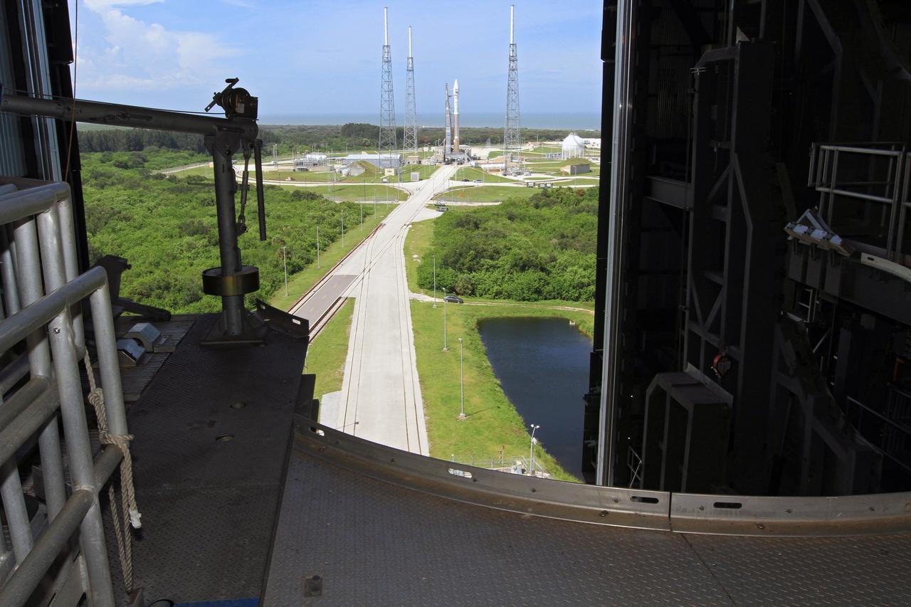 CAPE CANAVERAL, Fla. – A view from above inside the United Launch Alliance, or ULA, Vertical Integration Facility at Space Launch Complex 41 at Cape Canaveral Air Force Station in Florida, reveals the ULA Atlas V rocket carrying NASA’s twin Radiation Belt Storm Probes, or RBSP, secured at the pad. The Atlas V rocket rolled out of the integration facility at 1:59 p.m. EDT and was fully secured in position on the pad at 2:57 p.m. The Atlas V rocket had been rolled back to the facility on August 26 to ensure the launch vehicle and RBSP spacecraft were secured and protected from inclement weather caused by Tropical Storm Isaac.    RBSP will explore changes in Earth's space environment caused by the sun -- known as "space weather" -- that can disable satellites, create power-grid failures and disrupt GPS service. The mission also will provide data on the fundamental radiation and particle acceleration processes throughout the universe. The launch is rescheduled for 4:05 a.m. EDT on Aug. 30. For more information on RBSP, visit http://www.nasa.gov/rbsp.  Photo credit: NASA/Kim Shiflett