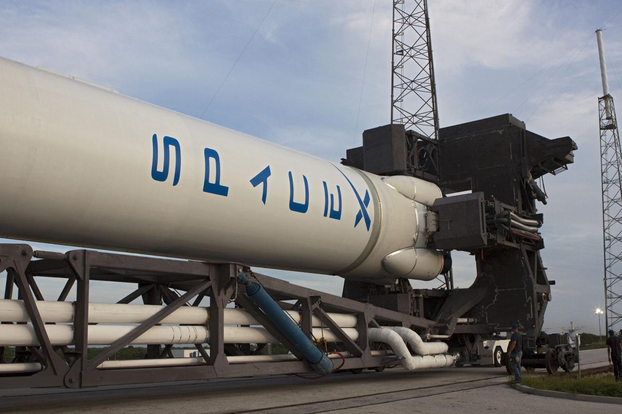 CAPE CANAVERAL, Fla. -- The Space Exploration Technologies, or SpaceX, Falcon 9 rocket rolls out of its processing hangar toward Space Launch Complex 40 at Cape Canaveral Air Force Station in Florida for a wet dress rehearsal. During the rehearsal, the rocket will be fully fueled and launch controllers will perform a countdown demonstration. The rehearsal is in preparation for the company's first Commercial Resupply Services, or CRS, mission to the International Space Station aboard the Dragon capsule.   The SpaceX CRS contract with NASA provides for 12 cargo resupply missions to the station through 2015, the first of which is targeted to launch in October 2012.SpaceX became the first private company to berth a spacecraft with the space station in 2012 during its final demonstration flight under the Commercial Orbital Transportation Services, or COTS, program managed by NASA's Johnson Space Center in Houston. Photo credit: NASA/Jim Grossmann