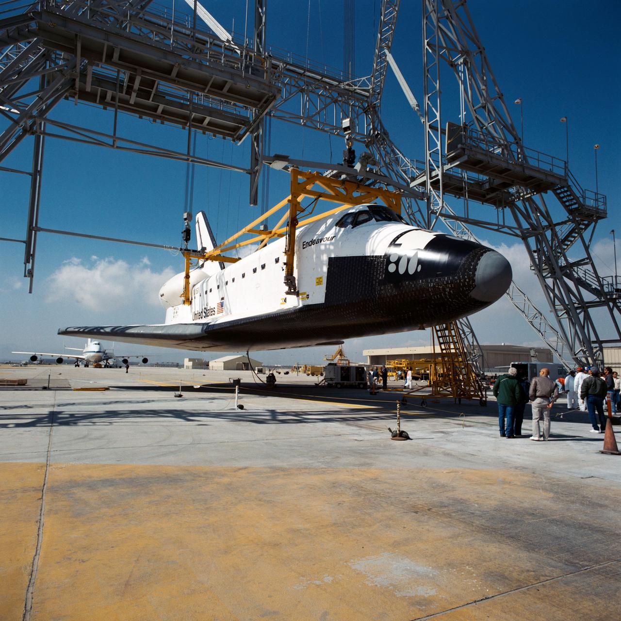 PALMDALE, Calif. -- S91-39487 -- A Rockwell worker at the space shuttle's Palmdale Final Assembly Facility in Palmdale, Calif., takes a technical documentation image of space shuttle Endeavour as it is prepared for its first ferry flight to NASA's Kennedy Space Center in Florida aboard the agency's Shuttle Carrier Aircraft, or SCA, designated NASA 911. Endeavour is scheduled to return to California in 2012, where it will be on public display at the California Science Center in Los Angeles. Its ferry flight across America is targeted for mid-September. Endeavour was the last space shuttle added to NASA’s orbiter fleet. During the course of its 19-year career, Endeavour spent 299 days in space during 25 missions. For more information on shuttle transition and retirement work, visit http://www.nasa.gov/transition. Photo credit: NASA/ Rockwell International Space Systems Division