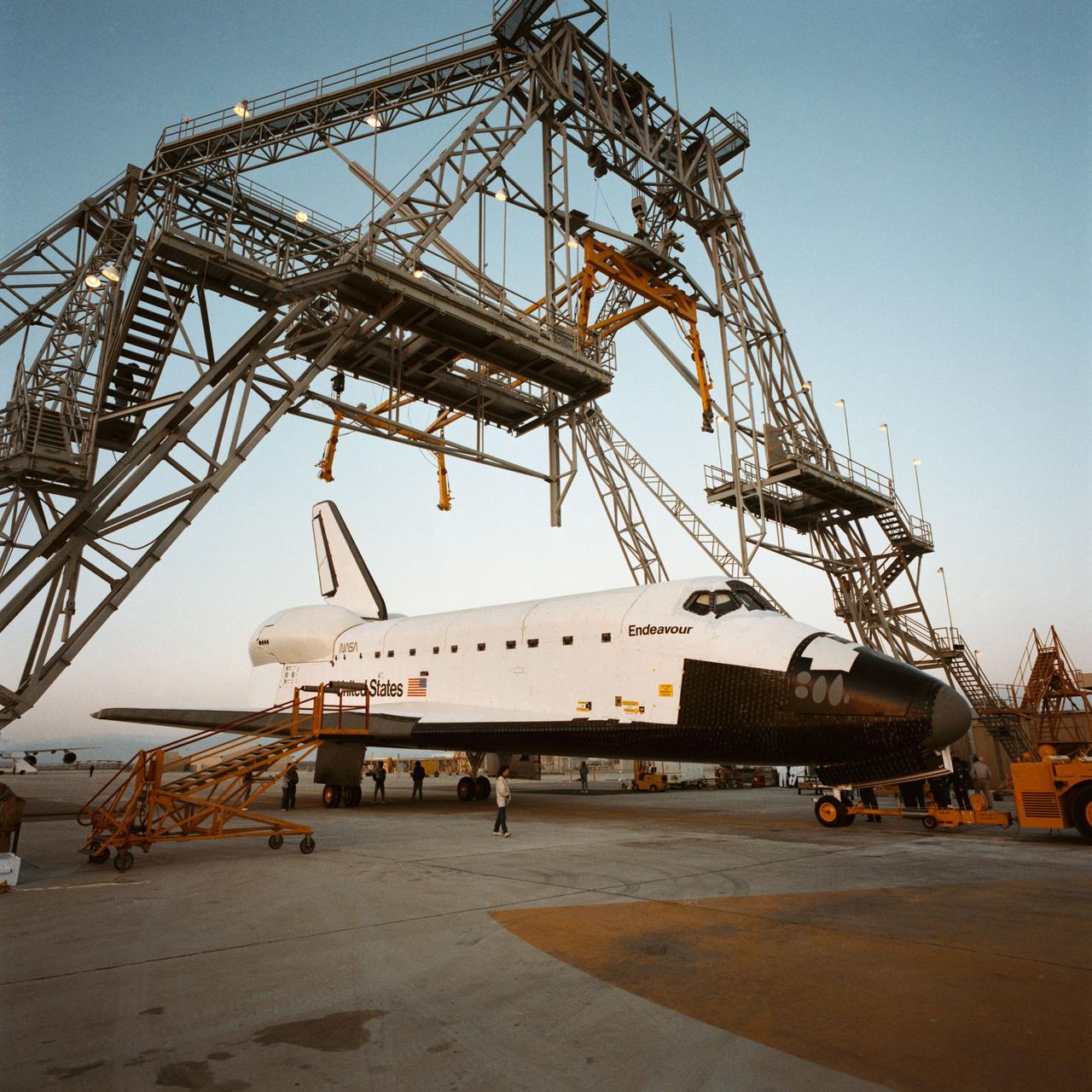 PALMDALE, Calif. -- S91-39480 -- A Rockwell worker at the space shuttle's Palmdale Final Assembly Facility in Palmdale, Calif., takes a technical documentation image of space shuttle Endeavour as it is prepared for its first ferry flight to NASA's Kennedy Space Center in Florida aboard the agency's Shuttle Carrier Aircraft, or SCA, designated NASA 911.     Endeavour is scheduled to return to California in 2012, where it will be on public display at the California Science Center in Los Angeles. Its ferry flight across America is targeted for mid-September. Endeavour was the last space shuttle added to NASA’s orbiter fleet. During the course of its 19-year career, Endeavour spent 299 days in space during 25 missions. For more information on shuttle transition and retirement work, visit http://www.nasa.gov/transition. Photo credit: NASA/ Rockwell International Space Systems Division