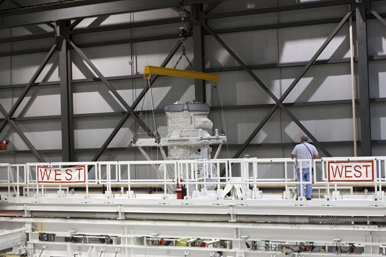 CAPE CANAVERAL, Fla. – At NASA's Kennedy Space Center in Florida, a crane is used to lift a mock air lock being prepared for installation in the payload bay of the space shuttle Atlantis in Bay 2 of the Orbiter Processing Facility. Atlantis is undergoing final preparations for its transfer to the Kennedy Space Center Visitor Complex targeted for November.      The work is part of Transition and Retirement of the remaining space shuttles, Atlantis and Endeavour. Atlantis is being prepared for public display at Kennedy's Visitor Complex. Over the course of its 26-year career, Atlantis spent 293 days in space during 33 missions. For more information, visit http://www.nasa.gov/transition Photo credit: NASA/Jim Grossmann