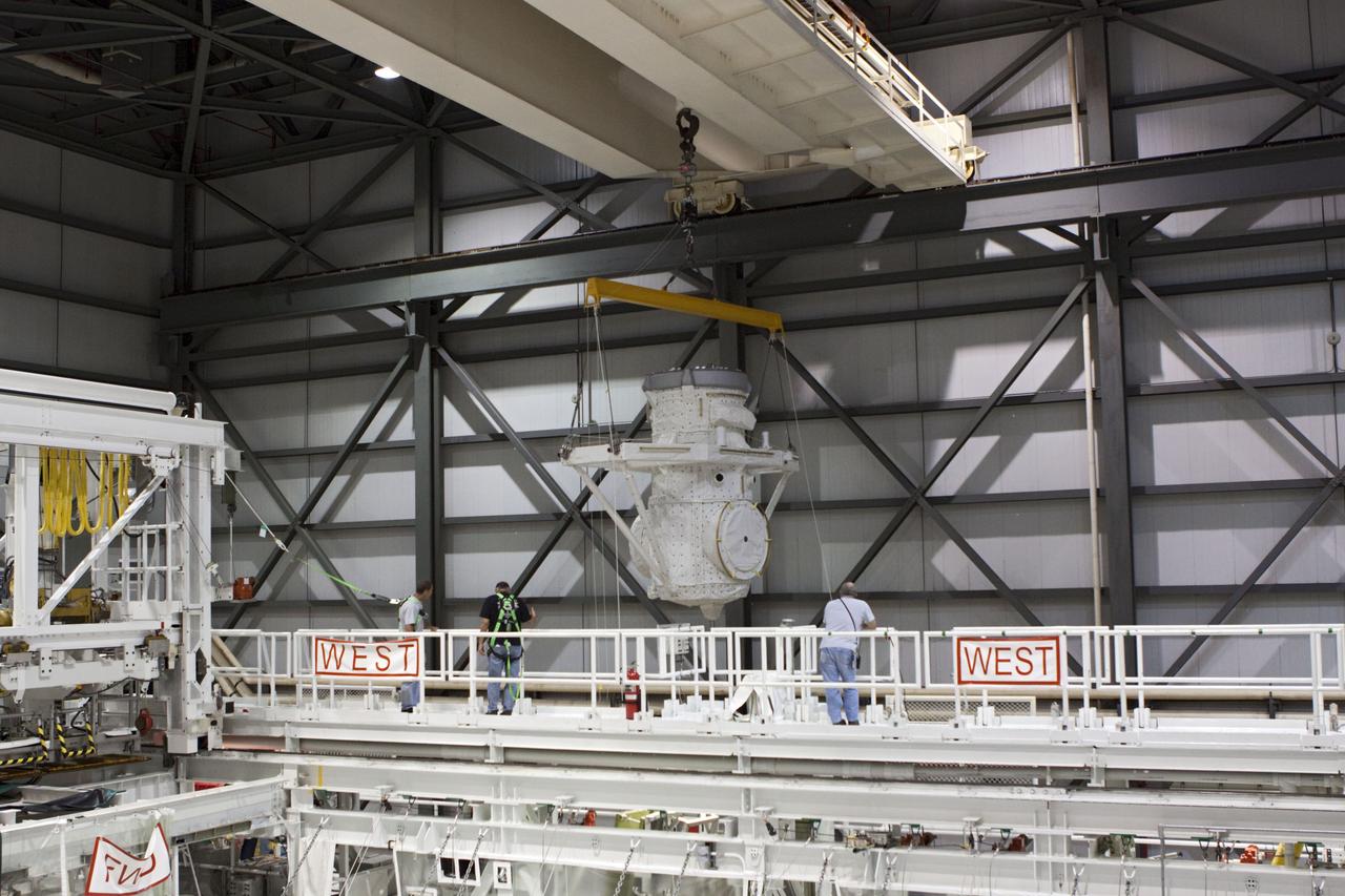 CAPE CANAVERAL, Fla. – At NASA's Kennedy Space Center in Florida, a crane is used to lift a mock air lock being prepared for installation in the payload bay of the space shuttle Atlantis in Bay 2 of the Orbiter Processing Facility. Atlantis is undergoing final preparations for its transfer to the Kennedy Space Center Visitor Complex targeted for November.      The work is part of Transition and Retirement of the remaining space shuttles, Atlantis and Endeavour. Atlantis is being prepared for public display at Kennedy's Visitor Complex. Over the course of its 26-year career, Atlantis spent 293 days in space during 33 missions. For more information, visit http://www.nasa.gov/transition Photo credit: NASA/Jim Grossmann