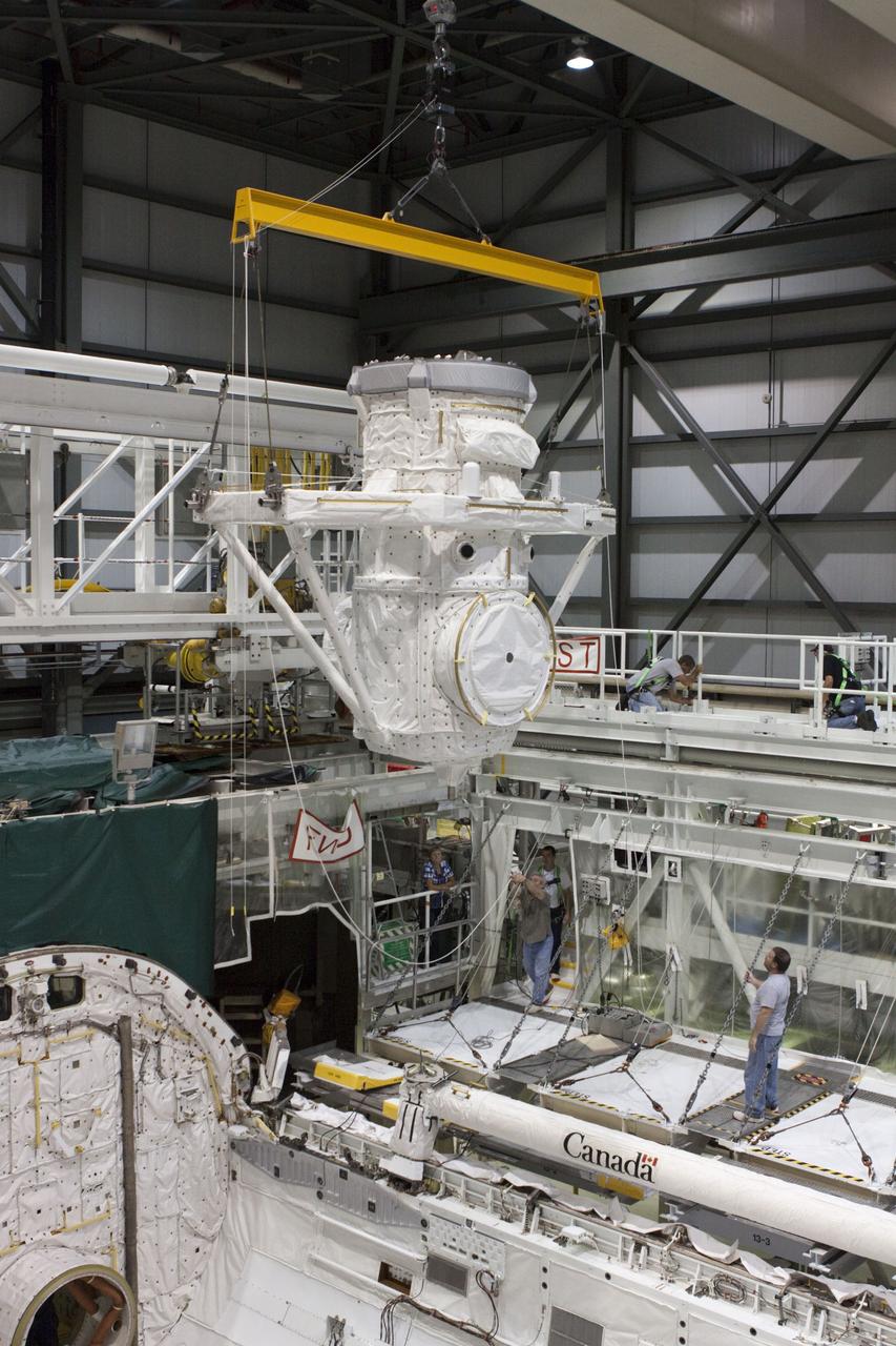 CAPE CANAVERAL, Fla. – At NASA's Kennedy Space Center in Florida, a crane is used to lift a mock air lock being prepared for installation in the payload bay of the space shuttle Atlantis in Bay 2 of the Orbiter Processing Facility. Atlantis is undergoing final preparations for its transfer to the Kennedy Space Center Visitor Complex targeted for November.      The work is part of Transition and Retirement of the remaining space shuttles, Atlantis and Endeavour. Atlantis is being prepared for public display at Kennedy's Visitor Complex. Over the course of its 26-year career, Atlantis spent 293 days in space during 33 missions. For more information, visit http://www.nasa.gov/transition Photo credit: NASA/Jim Grossmann