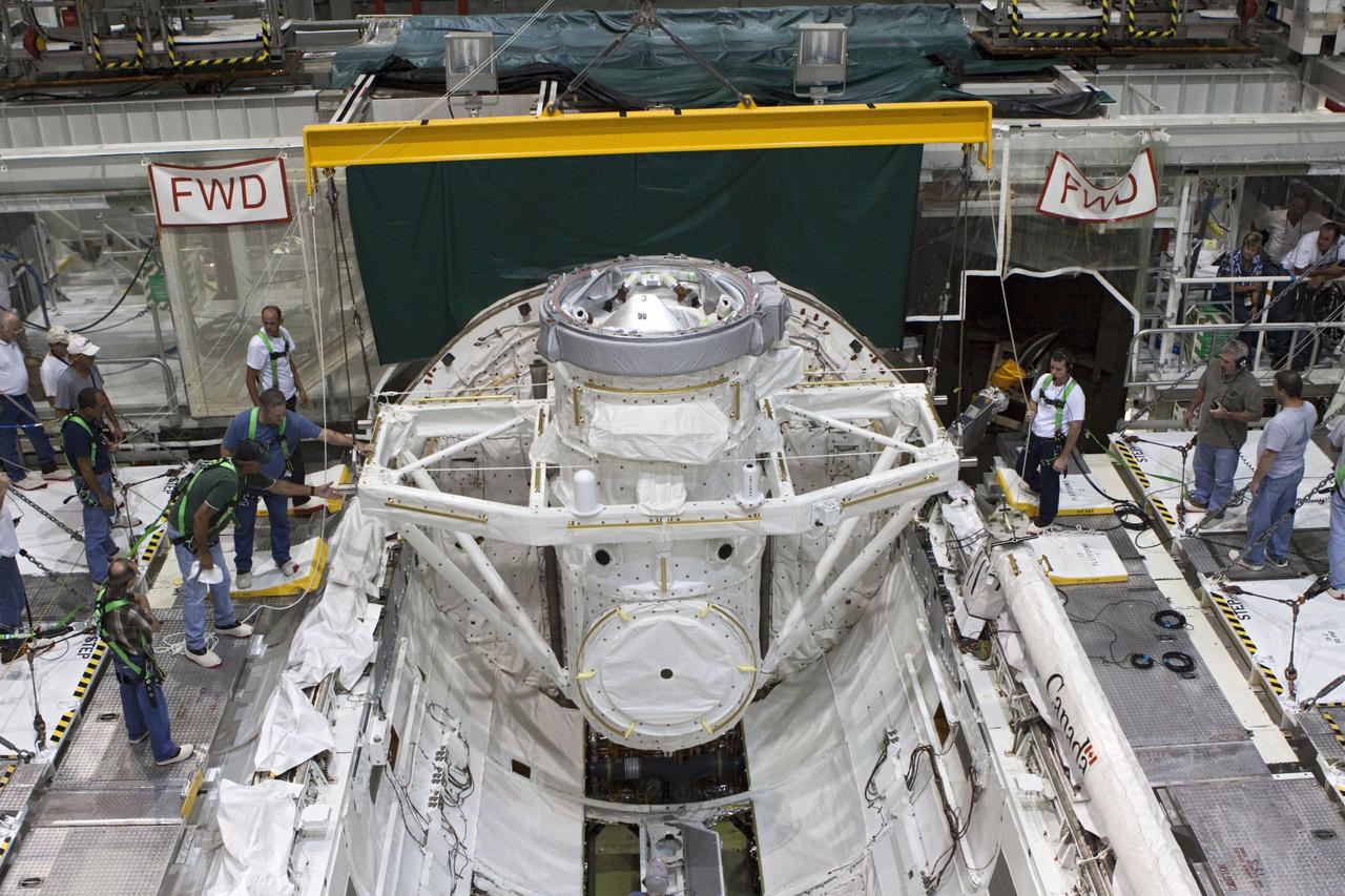 CAPE CANAVERAL, Fla. – At NASA's Kennedy Space Center in Florida, United Space Alliance technicians install a mock air lock in the payload bay of the space shuttle Atlantis in Bay 2 of the Orbiter Processing Facility. Atlantis is undergoing final preparations for its transfer to the Kennedy Space Center Visitor Complex targeted for November.      The work is part of Transition and Retirement of the remaining space shuttles, Atlantis and Endeavour. Atlantis is being prepared for public display at Kennedy's Visitor Complex. Over the course of its 26-year career, Atlantis spent 293 days in space during 33 missions. For more information, visit http://www.nasa.gov/transition Photo credit: NASA/Jim Grossmann