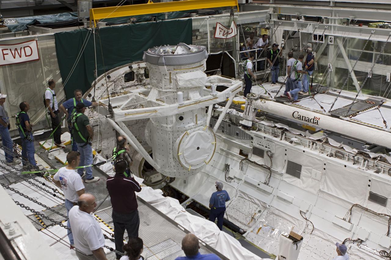 CAPE CANAVERAL, Fla. – At NASA's Kennedy Space Center in Florida, United Space Alliance technicians install a mock air lock in the payload bay of the space shuttle Atlantis in Bay 2 of the Orbiter Processing Facility. Atlantis is undergoing final preparations for its transfer to the Kennedy Space Center Visitor Complex targeted for November.      The work is part of Transition and Retirement of the remaining space shuttles, Atlantis and Endeavour. Atlantis is being prepared for public display at Kennedy's Visitor Complex. Over the course of its 26-year career, Atlantis spent 293 days in space during 33 missions. For more information, visit http://www.nasa.gov/transition Photo credit: NASA/Jim Grossmann