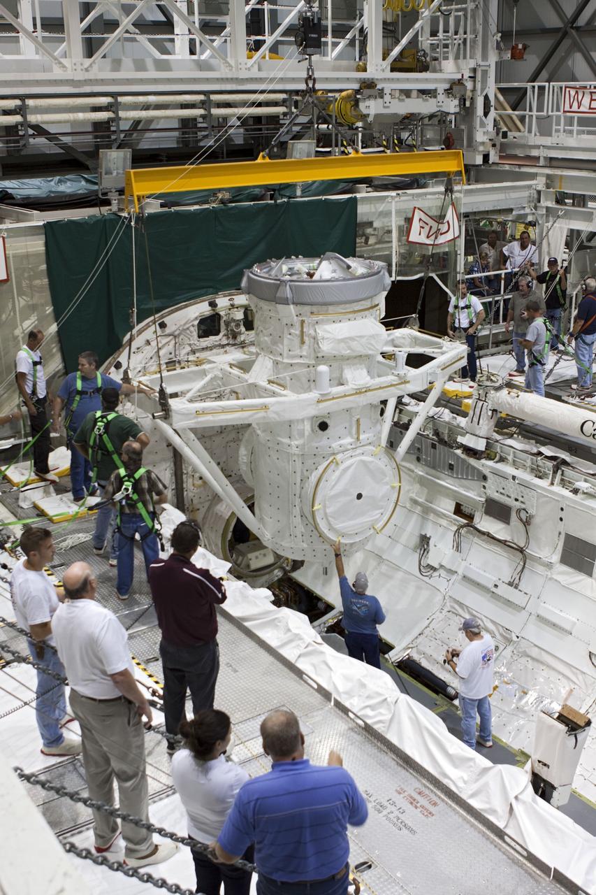 CAPE CANAVERAL, Fla. – At NASA's Kennedy Space Center in Florida, United Space Alliance technicians install a mock air lock in the payload bay of the space shuttle Atlantis in Bay 2 of the Orbiter Processing Facility. Atlantis is undergoing final preparations for its transfer to the Kennedy Space Center Visitor Complex targeted for November.      The work is part of Transition and Retirement of the remaining space shuttles, Atlantis and Endeavour. Atlantis is being prepared for public display at Kennedy's Visitor Complex. Over the course of its 26-year career, Atlantis spent 293 days in space during 33 missions. For more information, visit http://www.nasa.gov/transition Photo credit: NASA/Jim Grossmann