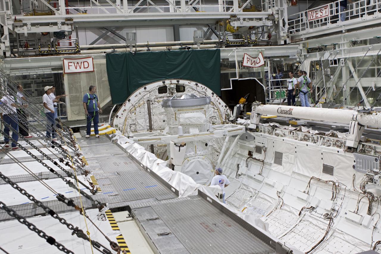 CAPE CANAVERAL, Fla. – At NASA's Kennedy Space Center in Florida, United Space Alliance technicians install a mock air lock in the payload bay of the space shuttle Atlantis in Bay 2 of the Orbiter Processing Facility. Atlantis is undergoing final preparations for its transfer to the Kennedy Space Center Visitor Complex targeted for November.      The work is part of Transition and Retirement of the remaining space shuttles, Atlantis and Endeavour. Atlantis is being prepared for public display at Kennedy's Visitor Complex. Over the course of its 26-year career, Atlantis spent 293 days in space during 33 missions. For more information, visit http://www.nasa.gov/transition Photo credit: NASA/Jim Grossmann