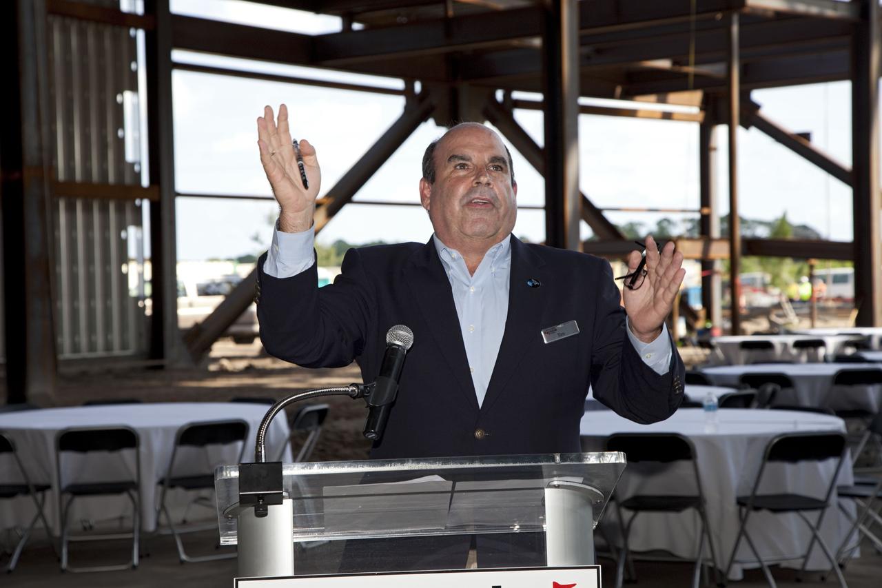 CAPE CANAVERAL, Fla. – Tim Macy, director of Project Development for the Kennedy Space Center Visitor Complex, speaks during a ceremony marking the placement of a steel beam at the highest point of a new exhibit facility under construction at the Kennedy Space Center Visitor Complex. The 90,000-square-foot facility will house space shuttle Atlantis and 62 shuttle program exhibits. Photo credit: NASA/Kim Shiflett