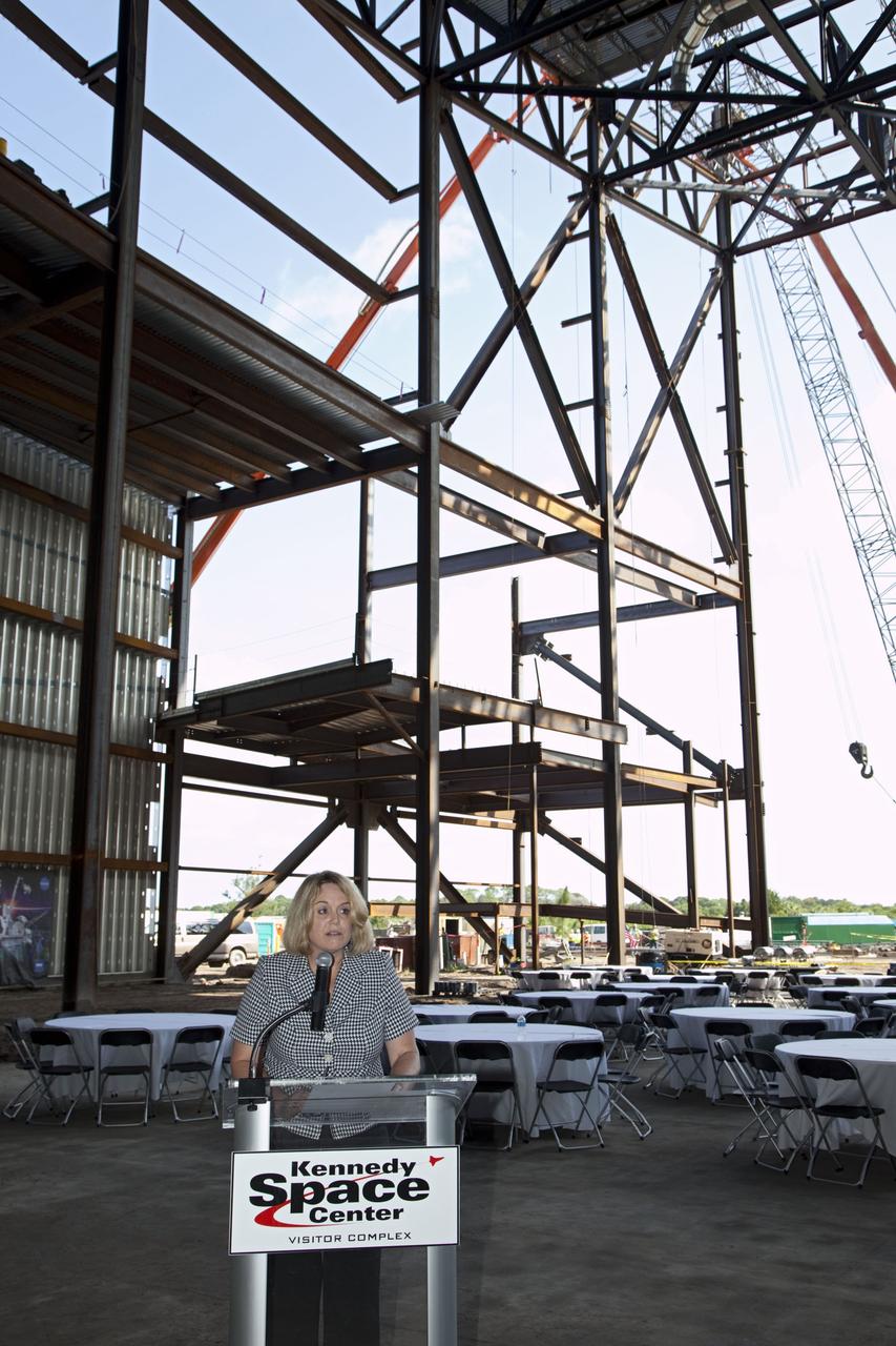 CAPE CANAVERAL, Fla. – Cheryl Hurst, director of Education and External Relations at NASA's Kennedy Space Center, speaks during a ceremony marking the placement of a steel beam at the highest point of a new exhibit facility under construction at the Kennedy Space Center Visitor Complex. The 90,000-square-foot facility will house space shuttle Atlantis and 62 shuttle program exhibits. Photo credit: NASA/Kim Shiflett
