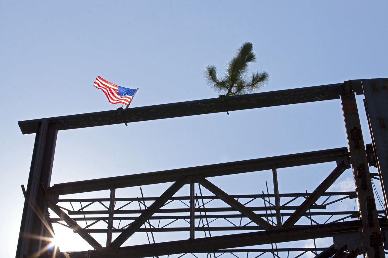 CAPE CANAVERAL, Fla. – A steel beam after being fitted to the highest point of a new exhibit facility under construction at the Kennedy Space Center Visitor Complex. The 90,000-square-foot facility will house space shuttle Atlantis and 62 shuttle program exhibits. Photo credit: NASA/Kim Shiflett