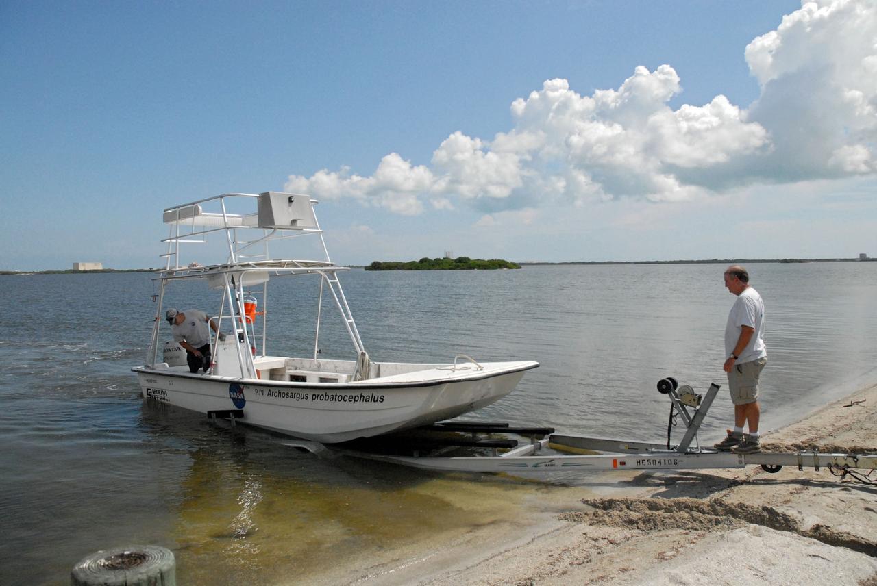 CAPE CANAVERAL, Fla. – Aquatic biologists Eric Reyier, left, and Doug Scheidt with Innovative Health Applications, or IHA, prepare for a field-guided boat tour of NASA's Kennedy Space Center in Florida. As part of the center's first-ever Innovation Expo, the tour, called "Living Outdoor Laboratory for Environmental Sustainability," is giving employees the opportunity to see the unique estuarine ecosystems that are protected from development by the presence of Kennedy and the Merritt Island National Wildlife Refuge.       The diverse and healthy area encompassing about 140,000 acres of central Florida's east coast has been closed to the public for 50 years, allowing the coastal dunes, saltwater estuaries and marshes, freshwater impoundments, scrub, pine flatwoods, and hardwood hammocks to provide habitats for more than 1,000 species of plants and animals. Innovation Expo is showcasing the innovative work taking place throughout the center's facilities and labs to encourage employees to work together to solve future challenges. For more information, visit http://www.nasa.gov/kennedy. Photo credit: NASA