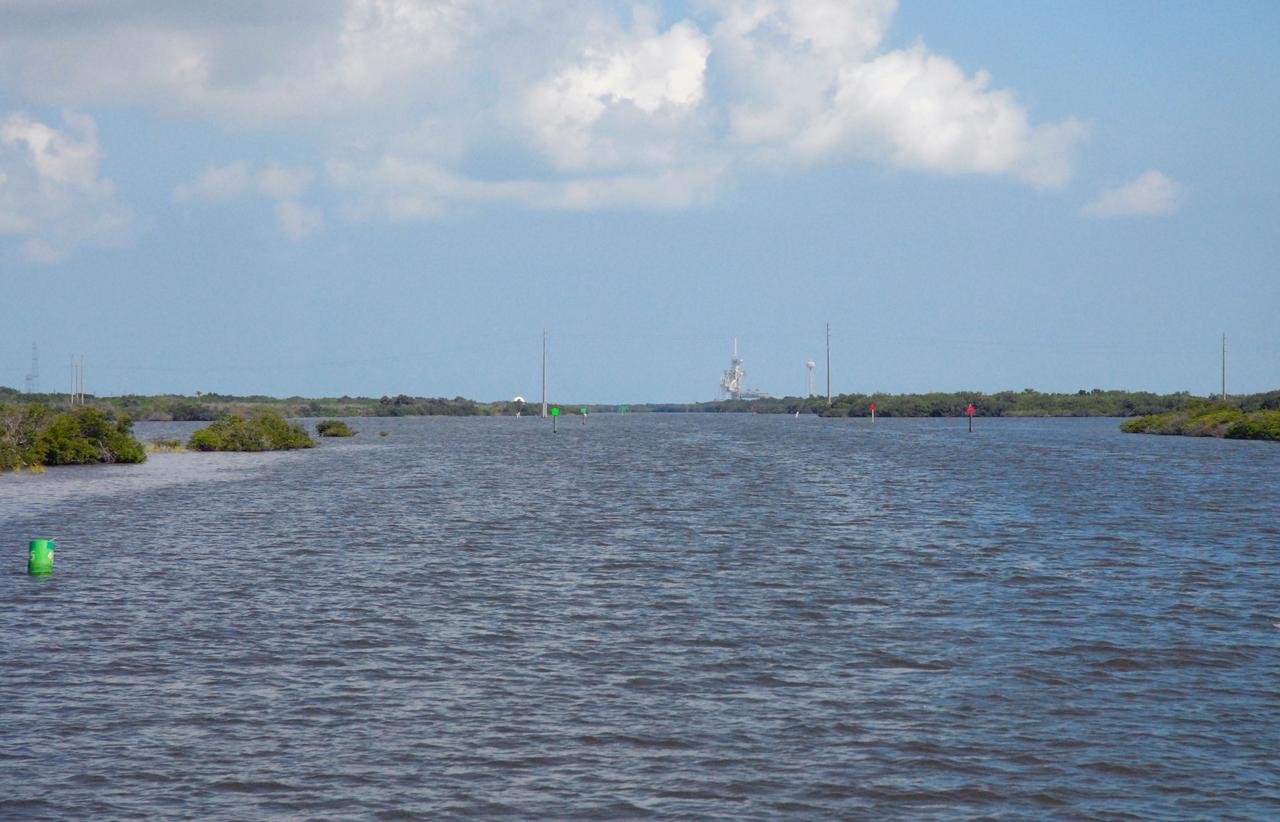 CAPE CANAVERAL, Fla. – Launch Pad 39A is seen in the distance during a field-guided boat tour of NASA's Kennedy Space Center in Florida. As part of the center's first-ever Innovation Expo, the tour, called "Living Outdoor Laboratory for Environmental Sustainability," is giving employees the opportunity to see the unique estuarine ecosystems that are protected from development by the presence of Kennedy and the Merritt Island National Wildlife Refuge.     The diverse and healthy area encompassing about 140,000 acres of central Florida's east coast has been closed to the public for 50 years, allowing the coastal dunes, saltwater estuaries and marshes, freshwater impoundments, scrub, pine flatwoods, and hardwood hammocks to provide habitats for more than 1,000 species of plants and animals. Innovation Expo is showcasing the innovative work taking place throughout the center's facilities and labs to encourage employees to work together to solve future challenges. For more information, visit http://www.nasa.gov/kennedy. Photo credit: NASA