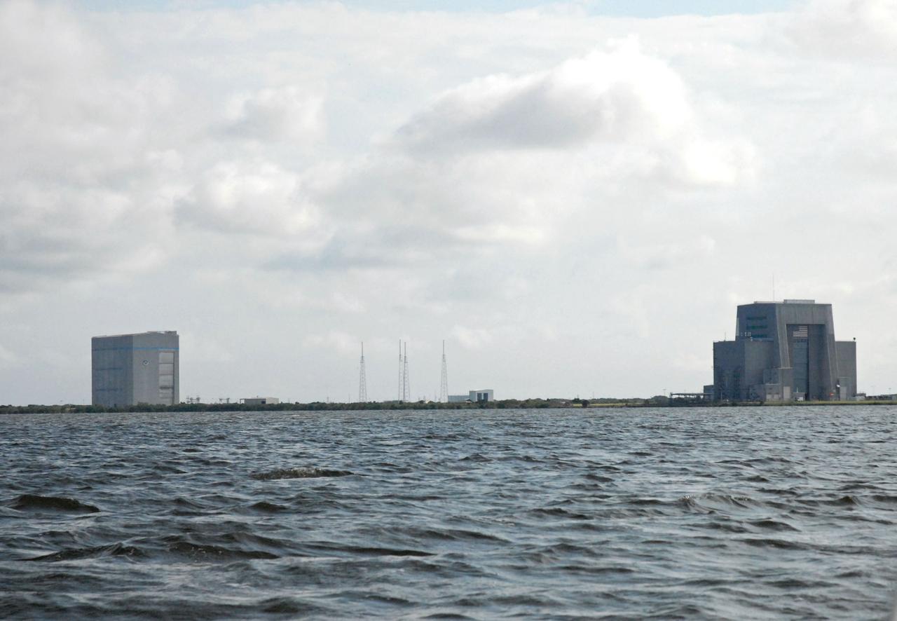 CAPE CANAVERAL, Fla. – Cape Canaveral Air Force Station's Solid Motor Assembly and Readiness Facility, or SMARF, Space Launch Complex 40, Space Exploration Technologies, or SpaceX, facility, and Solid Motor Assembly Building, or SMAB, are seen in the distance during a field-guided boat tour of NASA's Kennedy Space Center in Florida. As part of the center's first-ever Innovation Expo, the tour, called "Living Outdoor Laboratory for Environmental Sustainability," is giving employees the opportunity to see the unique estuarine ecosystems that are protected from development by the presence of Kennedy and the Merritt Island National Wildlife Refuge.        The diverse and healthy area encompassing about 140,000 acres of central Florida's east coast has been closed to the public for 50 years, allowing the coastal dunes, saltwater estuaries and marshes, freshwater impoundments, scrub, pine flatwoods, and hardwood hammocks to provide habitats for more than 1,000 species of plants and animals. Innovation Expo is showcasing the innovative work taking place throughout the center's facilities and labs to encourage employees to work together to solve future challenges. For more information, visit http://www.nasa.gov/kennedy. Photo credit: NASA