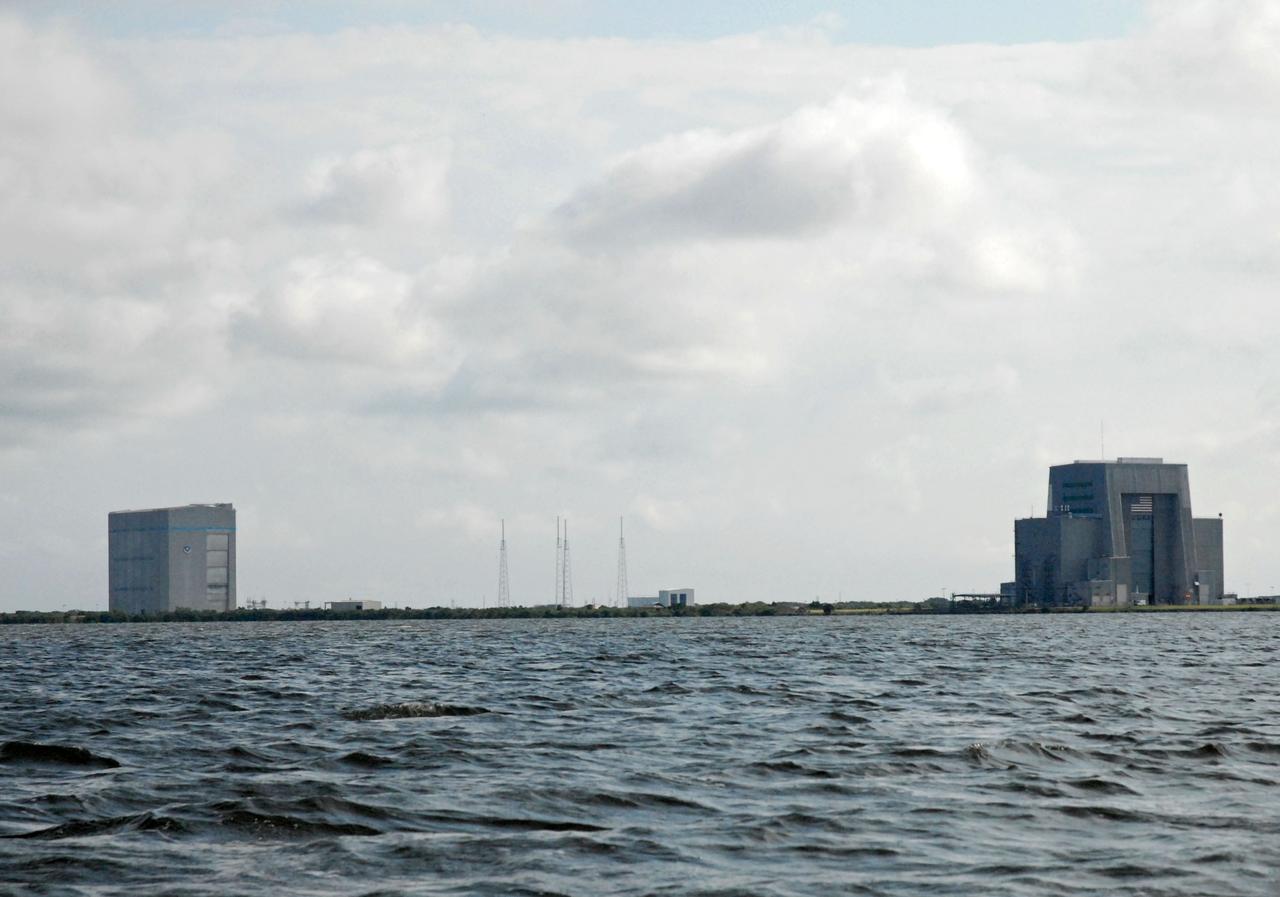 CAPE CANAVERAL, Fla. – The Vehicle Assembly Building, or VAB, is seen in the distance during a field-guided boat tour of NASA's Kennedy Space Center in Florida. As part of the center's first-ever Innovation Expo, the tour, called "Living Outdoor Laboratory for Environmental Sustainability," is giving employees the opportunity to see the unique estuarine ecosystems that are protected from development by the presence of Kennedy and the Merritt Island National Wildlife Refuge.           The diverse and healthy area encompassing about 140,000 acres of central Florida's east coast has been closed to the public for 50 years, allowing the coastal dunes, saltwater estuaries and marshes, freshwater impoundments, scrub, pine flatwoods, and hardwood hammocks to provide habitats for more than 1,000 species of plants and animals. Innovation Expo is showcasing the innovative work taking place throughout the center's facilities and labs to encourage employees to work together to solve future challenges. For more information, visit http://www.nasa.gov/kennedy. Photo credit: NASA