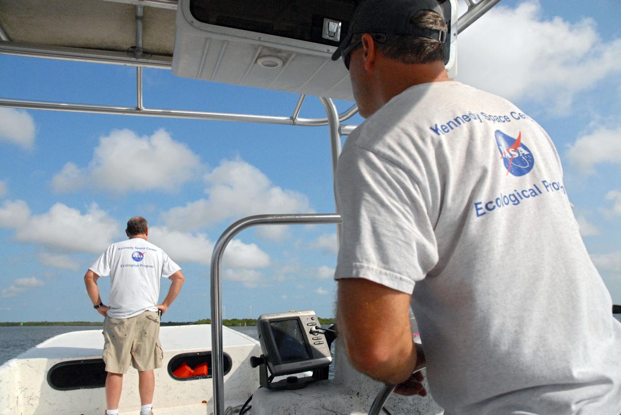CAPE CANAVERAL, Fla. – Aquatic biologist Eric Reyier with Innovative Health Applications, or IHA, drives a skiff boat during a field-guided tour of NASA's Kennedy Space Center in Florida. As part of the center's first-ever Innovation Expo, the tour, called "Living Outdoor Laboratory for Environmental Sustainability," is giving employees the opportunity to see the unique estuarine ecosystems that are protected from development by the presence of Kennedy and the Merritt Island National Wildlife Refuge. Aquatic biologist Doug Scheidt searches for landmarks and wildlife during the tour.        The diverse and healthy area encompassing about 140,000 acres of central Florida's east coast has been closed to the public for 50 years, allowing the coastal dunes, saltwater estuaries and marshes, freshwater impoundments, scrub, pine flatwoods, and hardwood hammocks to provide habitats for more than 1,000 species of plants and animals. Innovation Expo is showcasing the innovative work taking place throughout the center's facilities and labs to encourage employees to work together to solve future challenges. For more information, visit http://www.nasa.gov/kennedy. Photo credit: NASA