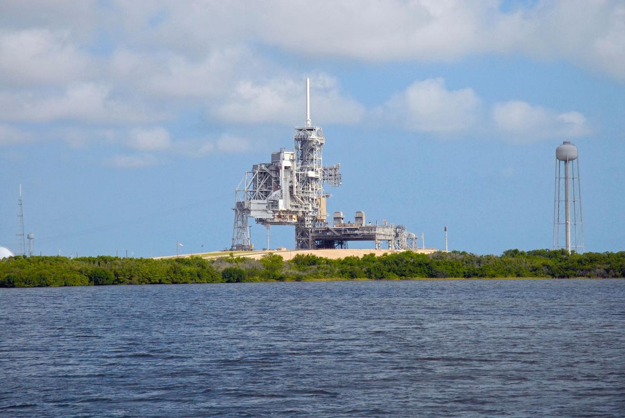 CAPE CANAVERAL, Fla. – Launch Pad 39A is seen during a field-guided boat tour of NASA's Kennedy Space Center in Florida. As part of the center's first-ever Innovation Expo, the tour, called "Living Outdoor Laboratory for Environmental Sustainability," is giving employees the opportunity to see the unique estuarine ecosystems that are protected from development by the presence of Kennedy and the Merritt Island National Wildlife Refuge.       The diverse and healthy area encompassing about 140,000 acres of central Florida's east coast has been closed to the public for 50 years, allowing the coastal dunes, saltwater estuaries and marshes, freshwater impoundments, scrub, pine flatwoods, and hardwood hammocks to provide habitats for more than 1,000 species of plants and animals. Innovation Expo is showcasing the innovative work taking place throughout the center's facilities and labs to encourage employees to work together to solve future challenges. For more information, visit http://www.nasa.gov/kennedy. Photo credit: NASA