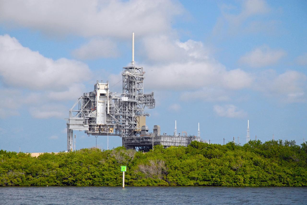 CAPE CANAVERAL, Fla. – Launch Pad 39A is seen during a field-guided boat tour of NASA's Kennedy Space Center in Florida. As part of the center's first-ever Innovation Expo, the tour, called "Living Outdoor Laboratory for Environmental Sustainability," is giving employees the opportunity to see the unique estuarine ecosystems that are protected from development by the presence of Kennedy and the Merritt Island National Wildlife Refuge.     The diverse and healthy area encompassing about 140,000 acres of central Florida's east coast has been closed to the public for 50 years, allowing the coastal dunes, saltwater estuaries and marshes, freshwater impoundments, scrub, pine flatwoods, and hardwood hammocks to provide habitats for more than 1,000 species of plants and animals. Innovation Expo is showcasing the innovative work taking place throughout the center's facilities and labs to encourage employees to work together to solve future challenges. For more information, visit http://www.nasa.gov/kennedy. Photo credit: NASA