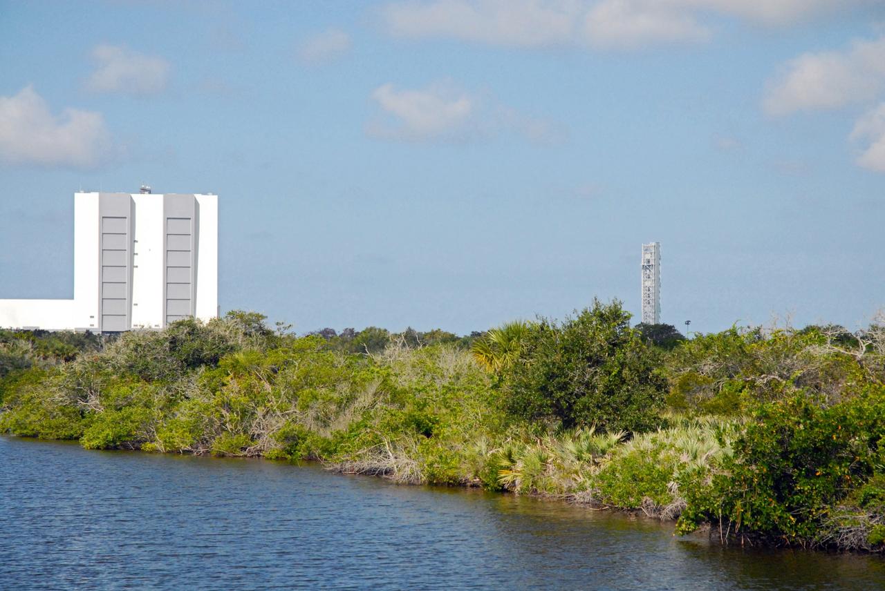 CAPE CANAVERAL, Fla. – The Vehicle Assembly Building, or VAB, and NASA's new mobile launcher, or ML, are seen in the distance during a field-guided boat tour of NASA's Kennedy Space Center in Florida. As part of the center's first-ever Innovation Expo, the tour, called "Living Outdoor Laboratory for Environmental Sustainability," is giving employees the opportunity to see the unique estuarine ecosystems that are protected from development by the presence of Kennedy and the Merritt Island National Wildlife Refuge. The 355-foot-tall ML structure, which took about two years to construct, will be modified by NASA’s Ground Systems Development and Operations, or GSDO, Program to support NASA’s Space Launch System, the heavy-lift rocket that will launch astronauts into deep space on future exploration missions.            The diverse and healthy area encompassing about 140,000 acres of central Florida's east coast has been closed to the public for 50 years, allowing the coastal dunes, saltwater estuaries and marshes, freshwater impoundments, scrub, pine flatwoods, and hardwood hammocks to provide habitats for more than 1,000 species of plants and animals. Innovation Expo is showcasing the innovative work taking place throughout the center's facilities and labs to encourage employees to work together to solve future challenges. For more information, visit http://www.nasa.gov/kennedy. Photo credit: NASA