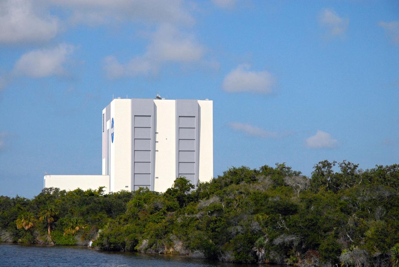CAPE CANAVERAL, Fla. – The Vehicle Assembly Building, or VAB, is seen during a field-guided boat tour of NASA's Kennedy Space Center in Florida. As part of the center's first-ever Innovation Expo, the tour, called "Living Outdoor Laboratory for Environmental Sustainability," is giving employees the opportunity to see the unique estuarine ecosystems that are protected from development by the presence of Kennedy and the Merritt Island National Wildlife Refuge.           The diverse and healthy area encompassing about 140,000 acres of central Florida's east coast has been closed to the public for 50 years, allowing the coastal dunes, saltwater estuaries and marshes, freshwater impoundments, scrub, pine flatwoods, and hardwood hammocks to provide habitats for more than 1,000 species of plants and animals. Innovation Expo is showcasing the innovative work taking place throughout the center's facilities and labs to encourage employees to work together to solve future challenges. For more information, visit http://www.nasa.gov/kennedy. Photo credit: NASA