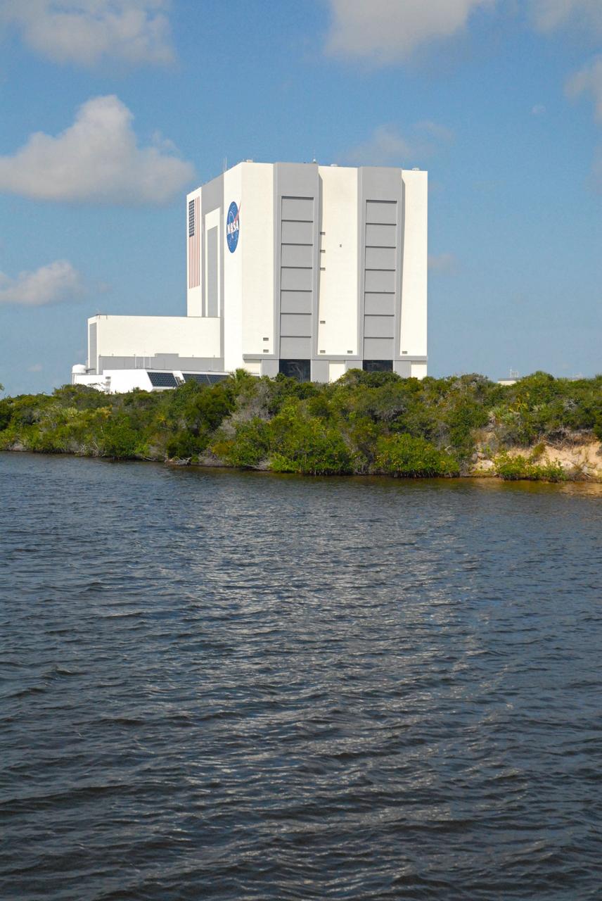 CAPE CANAVERAL, Fla. – The Vehicle Assembly Building, or VAB, is seen during a field-guided boat tour of NASA's Kennedy Space Center in Florida. As part of the center's first-ever Innovation Expo, the tour, called "Living Outdoor Laboratory for Environmental Sustainability," is giving employees the opportunity to see the unique estuarine ecosystems that are protected from development by the presence of Kennedy and the Merritt Island National Wildlife Refuge.       The diverse and healthy area encompassing about 140,000 acres of central Florida's east coast has been closed to the public for 50 years, allowing the coastal dunes, saltwater estuaries and marshes, freshwater impoundments, scrub, pine flatwoods, and hardwood hammocks to provide habitats for more than 1,000 species of plants and animals. Innovation Expo is showcasing the innovative work taking place throughout the center's facilities and labs to encourage employees to work together to solve future challenges. For more information, visit http://www.nasa.gov/kennedy. Photo credit: NASA