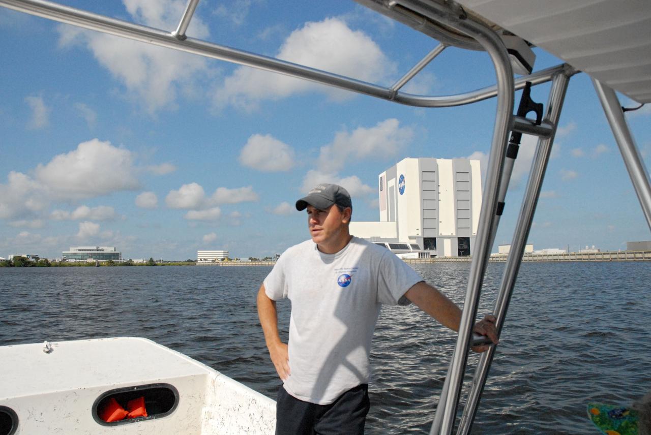 CAPE CANAVERAL, Fla. – Aquatic biologist Eric Reyier with Innovative Health Applications, or IHA, talks about the work that goes into protecting the natural habitat at a launch operations center during a field-guided boat tour of NASA's Kennedy Space Center in Florida. As part of the center's first-ever Innovation Expo, the tour, called "Living Outdoor Laboratory for Environmental Sustainability," is giving employees the opportunity to see the unique estuarine ecosystems that are protected from development by the presence of Kennedy and the Merritt Island National Wildlife Refuge. In the background is Kennedy's Launch Complex 39.      The diverse and healthy area encompassing about 140,000 acres of central Florida's east coast has been closed to the public for 50 years, allowing the coastal dunes, saltwater estuaries and marshes, freshwater impoundments, scrub, pine flatwoods, and hardwood hammocks to provide habitats for more than 1,000 species of plants and animals. Innovation Expo is showcasing the innovative work taking place throughout the center's facilities and labs to encourage employees to work together to solve future challenges. For more information, visit http://www.nasa.gov/kennedy. Photo credit: NASA