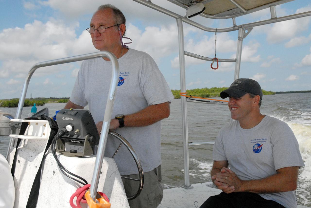 CAPE CANAVERAL, Fla. – Aquatic biologists Doug Scheidt, left, and Eric Reyier with Innovative Health Applications, or IHA, lead a field-guided boat tour of NASA's Kennedy Space Center in Florida. As part of the center's first-ever Innovation Expo, the tour, called "Living Outdoor Laboratory for Environmental Sustainability," is giving employees the opportunity to see the unique estuarine ecosystems that are protected from development by the presence of Kennedy and the Merritt Island National Wildlife Refuge.     The diverse and healthy area encompassing about 140,000 acres of central Florida's east coast has been closed to the public for 50 years, allowing the coastal dunes, saltwater estuaries and marshes, freshwater impoundments, scrub, pine flatwoods, and hardwood hammocks to provide habitats for more than 1,000 species of plants and animals. Innovation Expo is showcasing the innovative work taking place throughout the center's facilities and labs to encourage employees to work together to solve future challenges. For more information, visit http://www.nasa.gov/kennedy. Photo credit: NASA