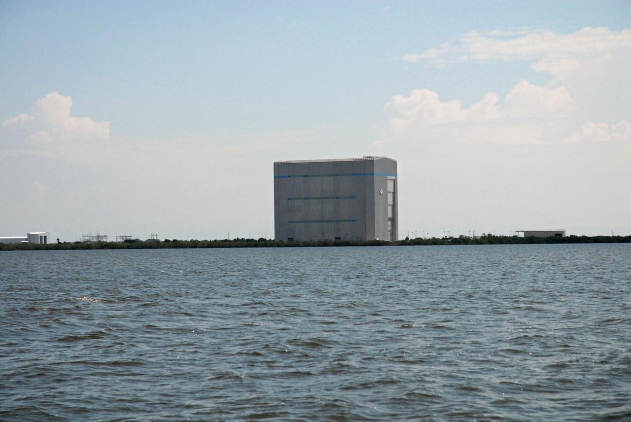 CAPE CANAVERAL, Fla. – Cape Canaveral Air Force Station's Solid Motor Assembly and Readiness Facility, or SMARF, Space Launch Complex 40, and Space Exploration Technologies, or SpaceX, facility, is seen in the distance during a field-guided boat tour of NASA's Kennedy Space Center in Florida. As part of the center's first-ever Innovation Expo, the tour, called "Living Outdoor Laboratory for Environmental Sustainability," is giving employees the opportunity to see the unique estuarine ecosystems that are protected from development by the presence of Kennedy and the Merritt Island National Wildlife Refuge.       The diverse and healthy area encompassing about 140,000 acres of central Florida's east coast has been closed to the public for 50 years, allowing the coastal dunes, saltwater estuaries and marshes, freshwater impoundments, scrub, pine flatwoods, and hardwood hammocks to provide habitats for more than 1,000 species of plants and animals. Innovation Expo is showcasing the innovative work taking place throughout the center's facilities and labs to encourage employees to work together to solve future challenges. For more information, visit http://www.nasa.gov/kennedy. Photo credit: NASA