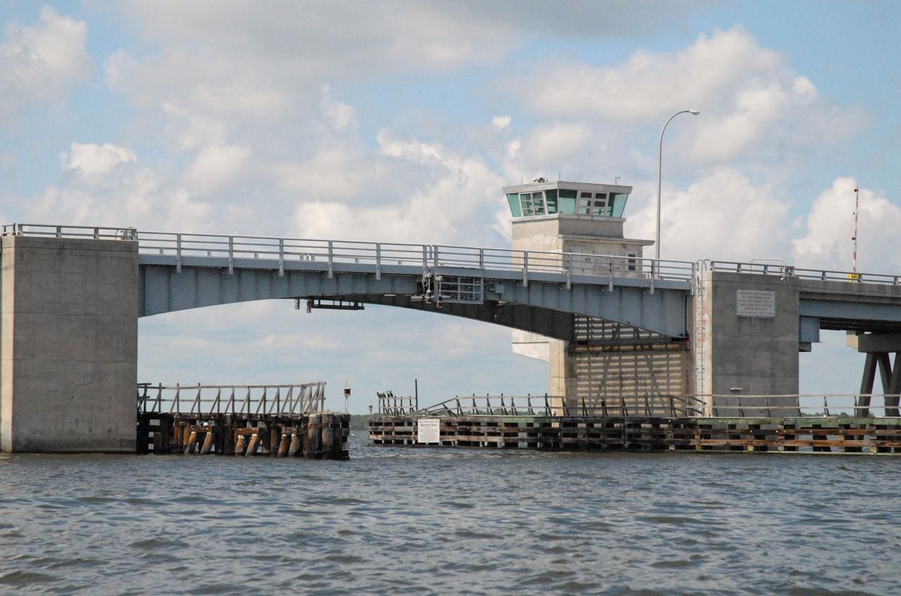 CAPE CANAVERAL, Fla. – The Roy D. Bridges Jr. Bridge connecting NASA Kennedy Space Center's Industrial Area to Cape Canaveral Air Force Station's Industrial Area is seen during a field-guided boat tour. As part of the Kennedy's first-ever Innovation Expo, the tour, called "Living Outdoor Laboratory for Environmental Sustainability," is giving employees the opportunity to see the unique estuarine ecosystems that are protected from development by the presence of the center and the Merritt Island National Wildlife Refuge.       The diverse and healthy area encompassing about 140,000 acres of central Florida's east coast has been closed to the public for 50 years, allowing the coastal dunes, saltwater estuaries and marshes, freshwater impoundments, scrub, pine flatwoods, and hardwood hammocks to provide habitats for more than 1,000 species of plants and animals. Innovation Expo is showcasing the innovative work taking place throughout the center's facilities and labs to encourage employees to work together to solve future challenges. For more information, visit http://www.nasa.gov/kennedy. Photo credit: NASA