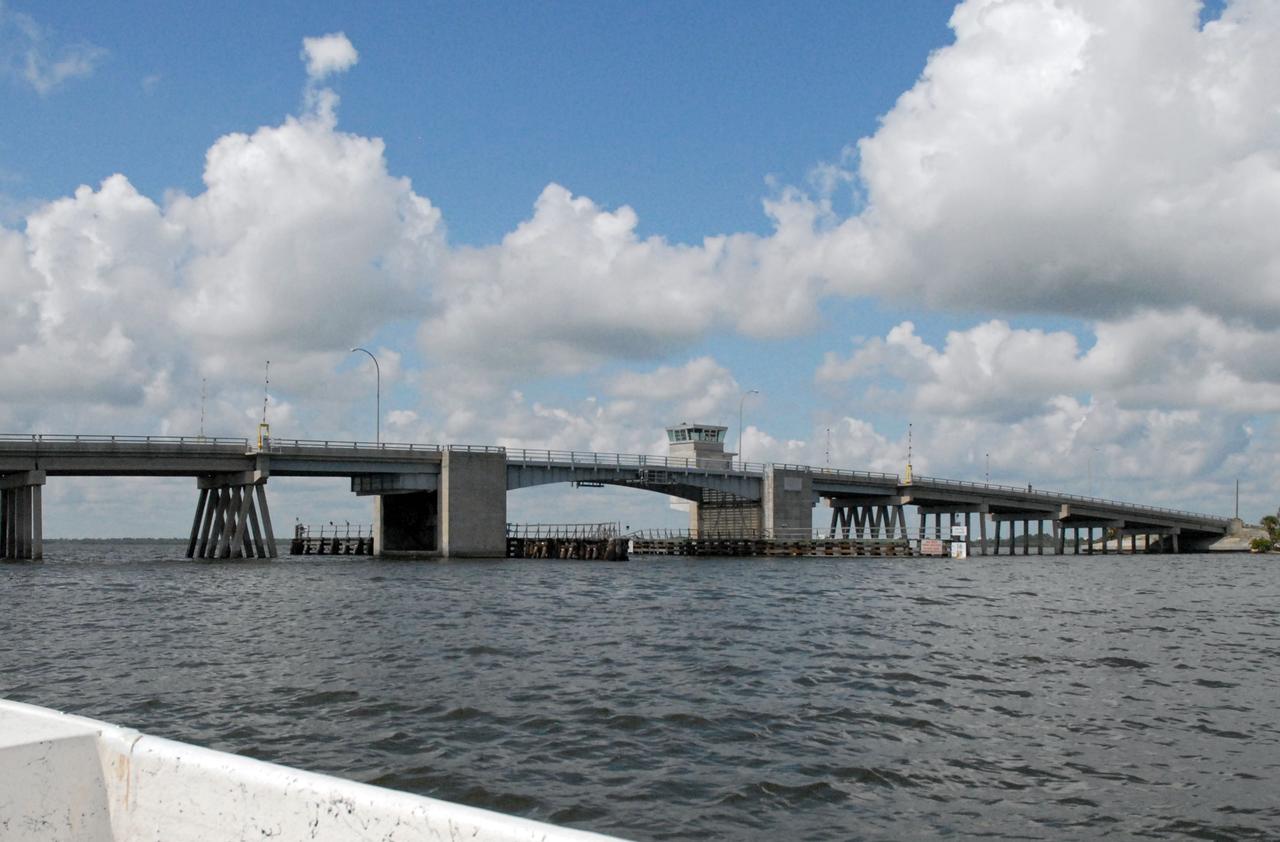 CAPE CANAVERAL, Fla. – The Roy D. Bridges Jr. Bridge connecting NASA Kennedy Space Center's Industrial Area to Cape Canaveral Air Force Station's Industrial Area is seen during a field-guided boat tour. As part of the Kennedy's first-ever Innovation Expo, the tour, called "Living Outdoor Laboratory for Environmental Sustainability," is giving employees the opportunity to see the unique estuarine ecosystems that are protected from development by the presence of the center and the Merritt Island National Wildlife Refuge.    The diverse and healthy area encompassing about 140,000 acres of central Florida's east coast has been closed to the public for 50 years, allowing the coastal dunes, saltwater estuaries and marshes, freshwater impoundments, scrub, pine flatwoods, and hardwood hammocks to provide habitats for more than 1,000 species of plants and animals. Innovation Expo is showcasing the innovative work taking place throughout the center's facilities and labs to encourage employees to work together to solve future challenges. For more information, visit http://www.nasa.gov/kennedy. Photo credit: NASA