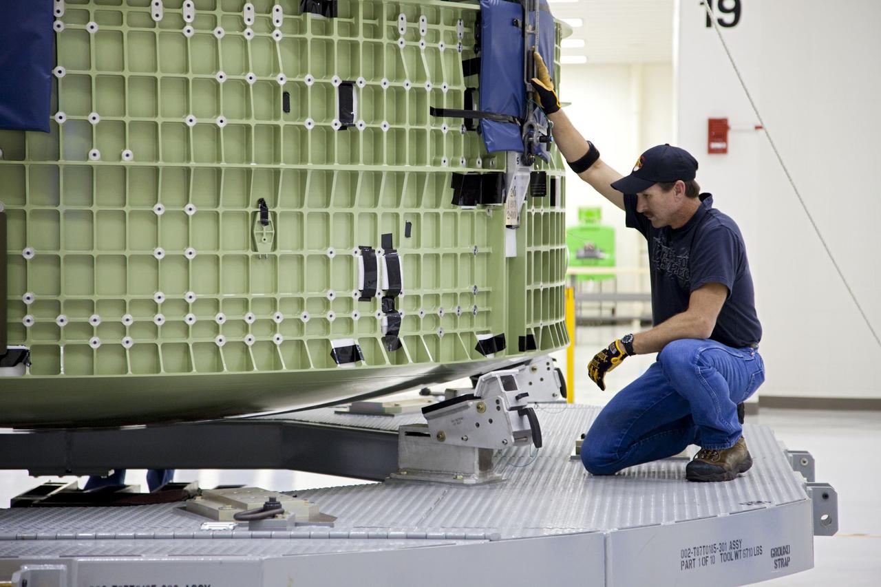 CAPE CANAVERAL, Fla. – Inside the Operations and Checkout Building high bay at NASA’s Kennedy Space Center in Florida, a technician attaches a crane to the Orion Exploration Flight Test 1 crew module so that it can be moved to the base of a birdcage tool. The birdcage will be used to continue installation of external components in preparation for Orion’s first uncrewed test flight in 2014 atop a Delta IV rocket. Orion is the exploration spacecraft designed to carry crews to space beyond low Earth orbit. It will provide emergency abort capability, sustain the crew during the space travel and provide safe re-entry from deep space return velocities. A second uncrewed flight test is scheduled for 2017 on NASA’s Space Launch System rocket. For more information, visit http://www.nasa.gov/orion. Photo credit: NASA/Kim Shiflett