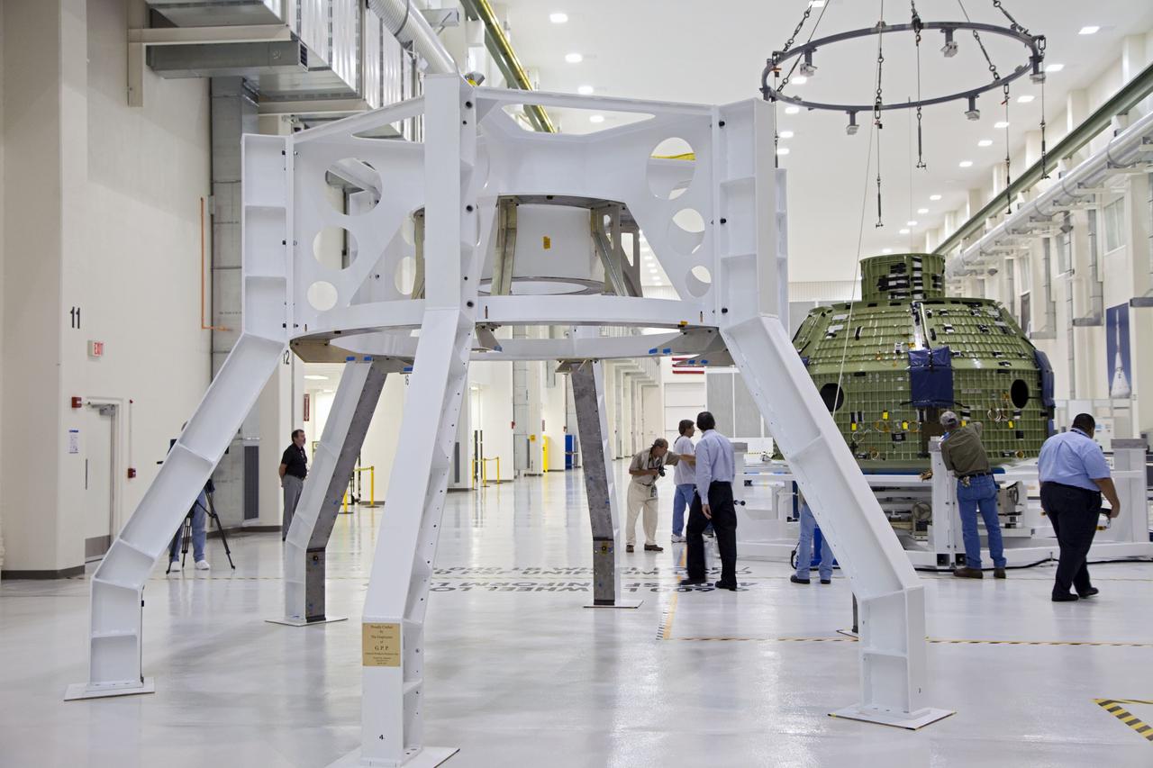 CAPE CANAVERAL, Fla. – Inside the Operations and Checkout Building at NASA’s Kennedy Space Center in Florida, technicians provide assistance as a crane lowers the Orion Exploration Flight Test 1 crew module onto the base of a birdcage tool. The birdcage will be used to continue installation of external components in preparation for Orion’s first uncrewed test flight in 2014 atop a Delta IV rocket. Orion is the exploration spacecraft designed to carry crews to space beyond low Earth orbit. It will provide emergency abort capability, sustain the crew during the space travel and provide safe re-entry from deep space return velocities. A second uncrewed flight test is scheduled for 2017 on NASA’s Space Launch System rocket. For more information, visit http://www.nasa.gov/orion. Photo credit: NASA/Kim Shiflett