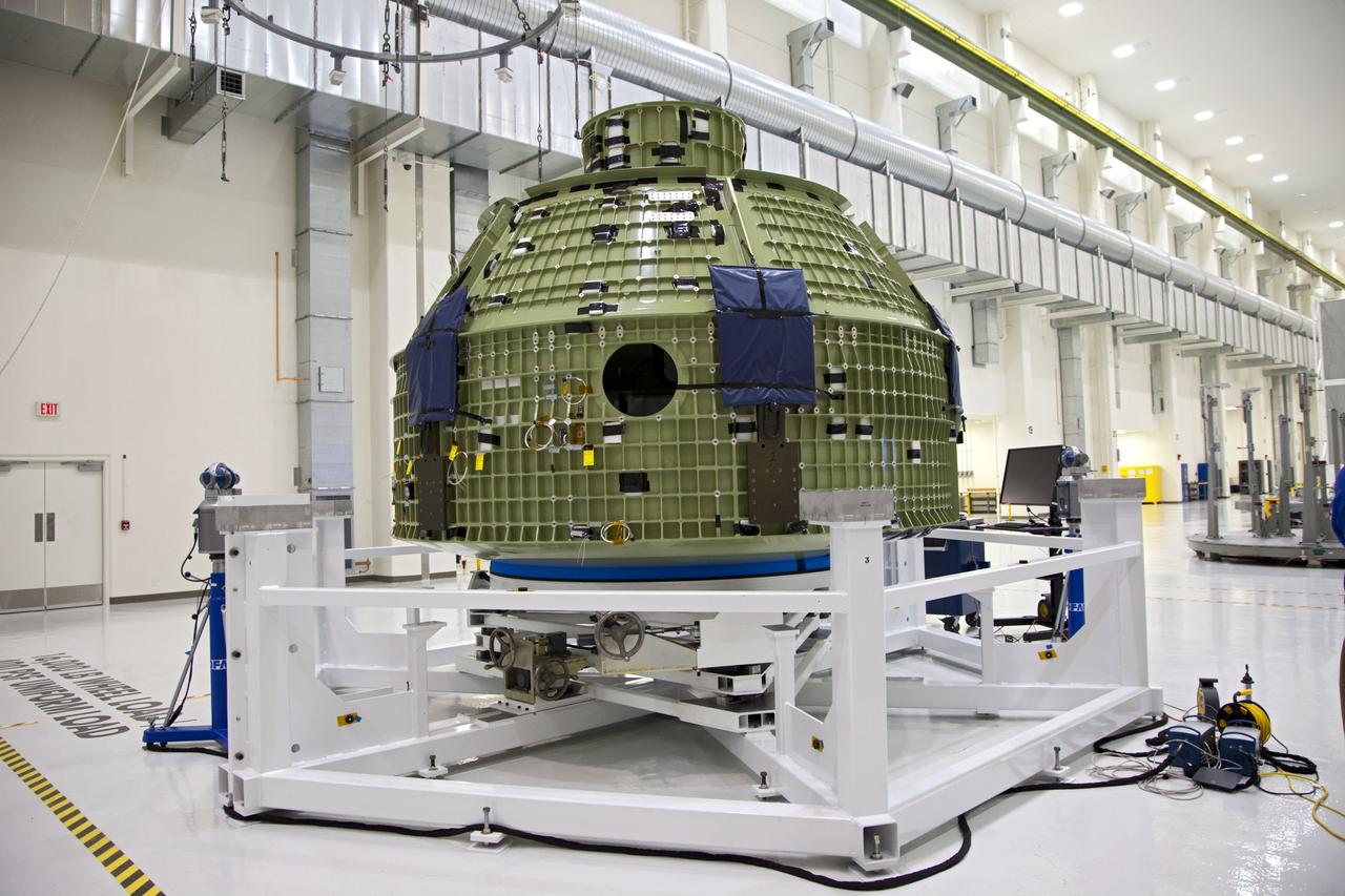 CAPE CANAVERAL, Fla. – Inside the Operations and Checkout Building at NASA’s Kennedy Space Center in Florida, the Orion Exploration Flight Test 1 crew module has been moved onto the base of a birdcage tool. The birdcage will be used to continue installation of external components in preparation for Orion’s first uncrewed test flight in 2014 atop a Delta IV rocket. Orion is the exploration spacecraft designed to carry crews to space beyond low Earth orbit. It will provide emergency abort capability, sustain the crew during the space travel and provide safe re-entry from deep space return velocities. A second uncrewed flight test is scheduled for 2017 on NASA’s Space Launch System rocket. For more information, visit http://www.nasa.gov/orion. Photo credit: NASA/Kim Shiflett
