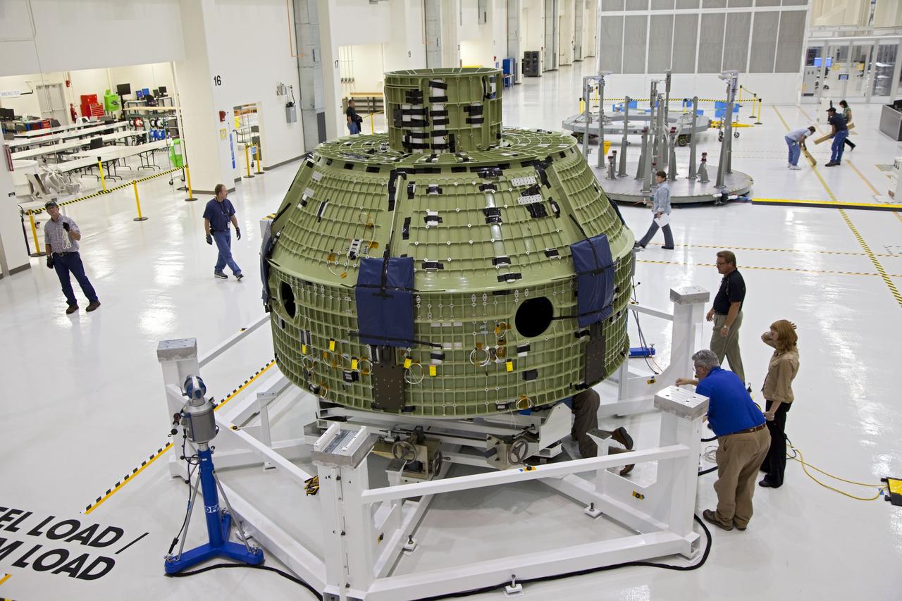 CAPE CANAVERAL, Fla. – Inside the Operations and Checkout Building at NASA’s Kennedy Space Center in Florida, the Orion Exploration Flight Test 1 crew module has been moved onto the base of a birdcage tool. The birdcage will be used to continue installation of external components in preparation for Orion’s first uncrewed test flight in 2014 atop a Delta IV rocket. Orion is the exploration spacecraft designed to carry crews to space beyond low Earth orbit. It will provide emergency abort capability, sustain the crew during the space travel and provide safe re-entry from deep space return velocities. A second uncrewed flight test is scheduled for 2017 on NASA’s Space Launch System rocket. For more information, visit http://www.nasa.gov/orion. Photo credit: NASA/Kim Shiflett