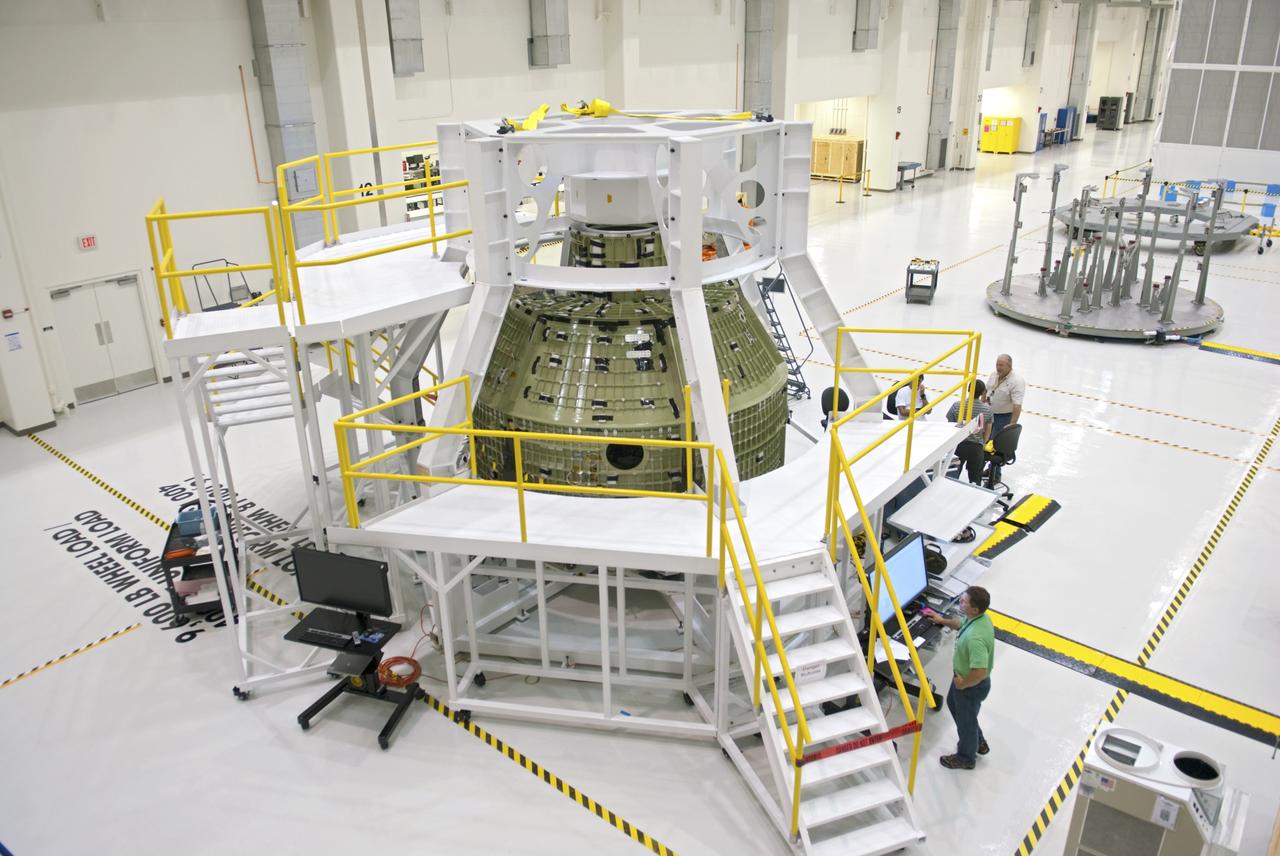 CAPE CANAVERAL, Fla. – Inside the Operations and Checkout Building at NASA’s Kennedy Space Center in Florida, a birdcage tool along with work platforms have been placed around the Orion Exploration Flight Test 1 crew module. The birdcage will be used to continue installation of external components in preparation for Orion’s first uncrewed test flight in 2014 atop a Delta IV rocket. Orion is the exploration spacecraft designed to carry crews to space beyond low Earth orbit. It will provide emergency abort capability, sustain the crew during the space travel and provide safe re-entry from deep space return velocities. A second uncrewed flight test is scheduled for 2017 on NASA’s Space Launch System rocket. For more information, visit http://www.nasa.gov/orion. Photo credit: NASA/Charisse Nahser