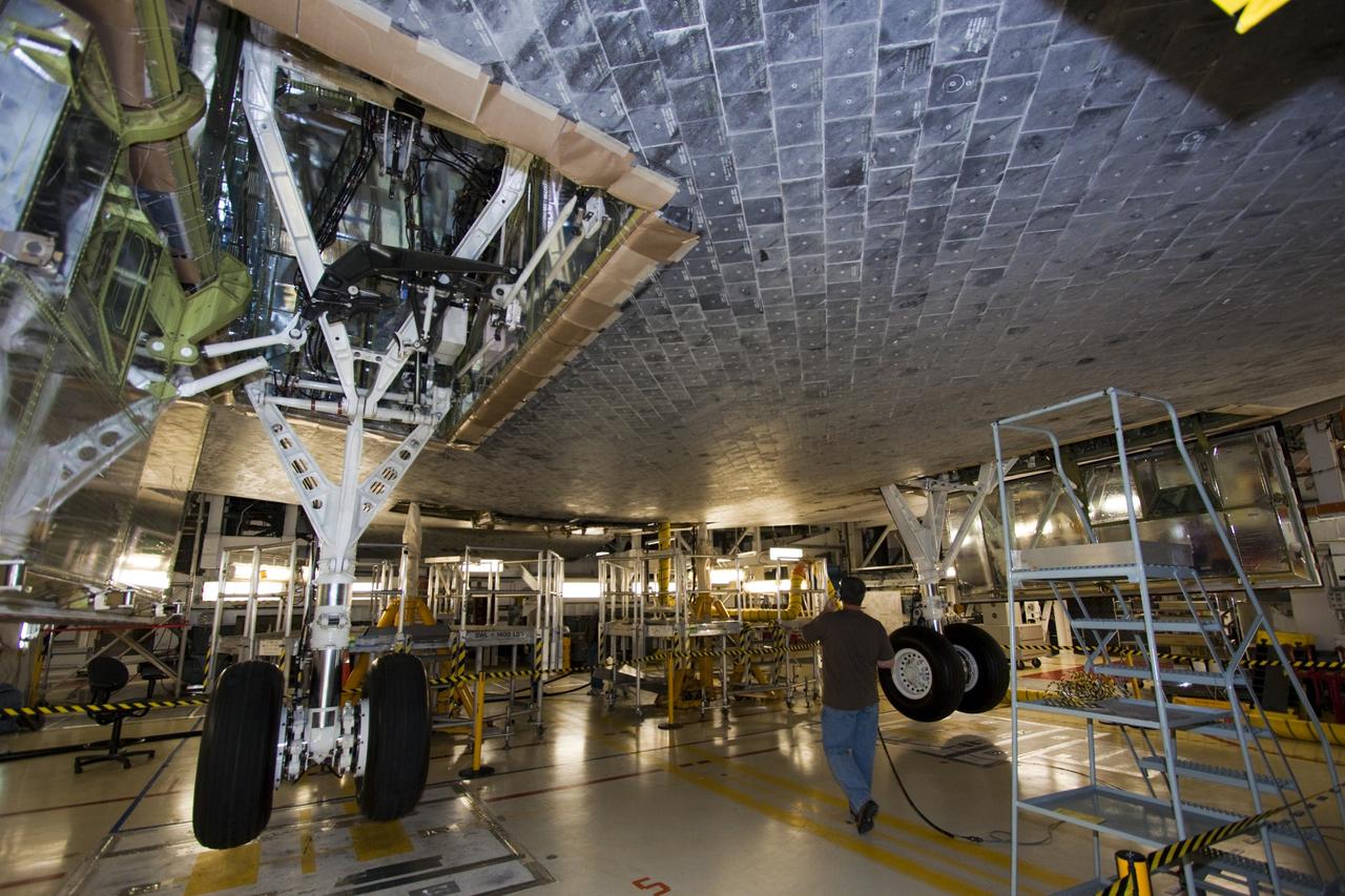 CAPE CANAVERAL, Fla. – A technician watches the main landing gear on space shuttle Atlantis during a landing gear functional test in Orbiter Processing Facility-2, where the shuttle is undergoing transition and retirement processing. Photo credit: NASA/Jim Grossmann