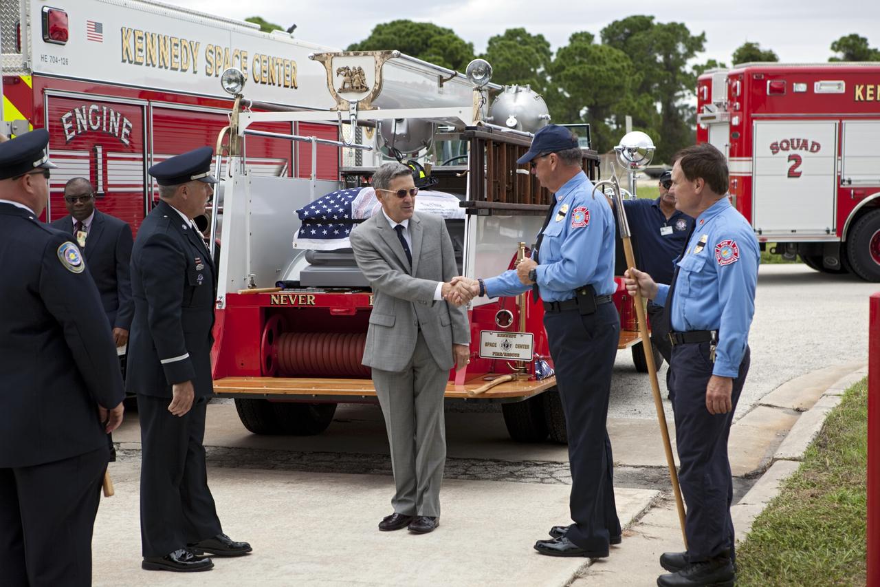 CAPE CANAVERAL, Fla. – NASA Kennedy Space Center’s Director Robert Cabana participates in a 9/11 memorial dedication in front of Fire Station 1 at Kennedy in Florida. Kennedy Fire and Rescue Services commemorated the 11th anniversary of 9/11 with a ceremony that included a minute of silence at 10:28 a.m., which was the moment of collapse of the north tower of the World Trade Center. Kennedy center-wide emergency units dispatched by Fire Control engaged in one-minute sirens, the new memorial was dedicated and the Honor Guard performed a flag-folding ceremony. Photo credit: NASA/Dimitri Gerondidakis
