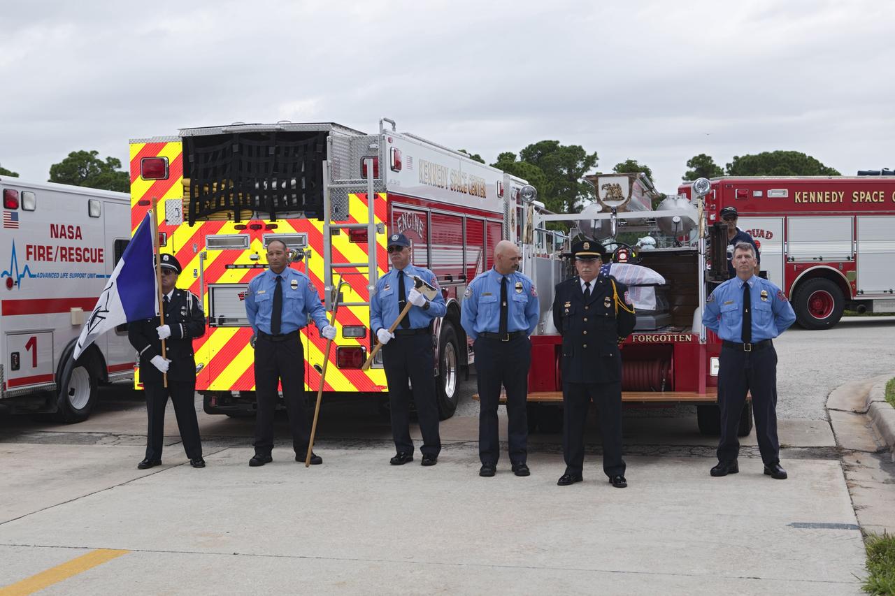 CAPE CANAVERAL, Fla. – NASA Kennedy Space Center’s Fire and Rescue personnel stand at attention during a 9/11 memorial dedication ceremony in front of Fire Station 1 at Kennedy in Florida.    Kennedy Fire and Rescue Services commemorated the 11th anniversary of 9/11 with a ceremony that included a minute of silence at 10:28 a.m., which was the moment of collapse of the north tower of the World Trade Center. Kennedy center-wide emergency units dispatched by Fire Control engaged in one-minute sirens, the new memorial was dedicated and the Honor Guard performed a flag-folding ceremony. Photo credit: NASA/Dimitri Gerondidakis