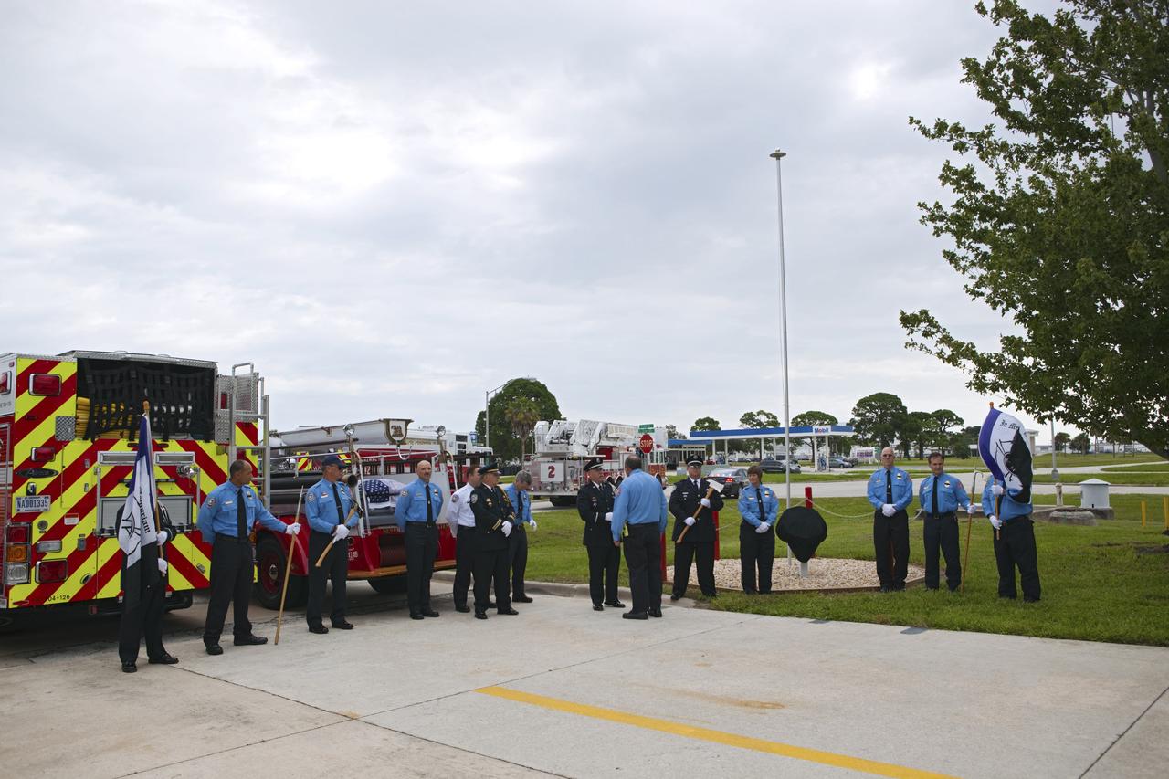 CAPE CANAVERAL, Fla. – NASA Kennedy Space Center’s Fire and Rescue personnel stand at attention during a 9/11 memorial dedication ceremony in front of Fire Station 1 at Kennedy in Florida.    Kennedy Fire and Rescue Services commemorated the 11th anniversary of 9/11 with a ceremony that included a minute of silence at 10:28 a.m., which was the moment of collapse of the north tower of the World Trade Center. Kennedy center-wide emergency units dispatched by Fire Control engaged in one-minute sirens, the new memorial was dedicated and the Honor Guard performed a flag-folding ceremony. Photo credit: NASA/Dimitri Gerondidakis