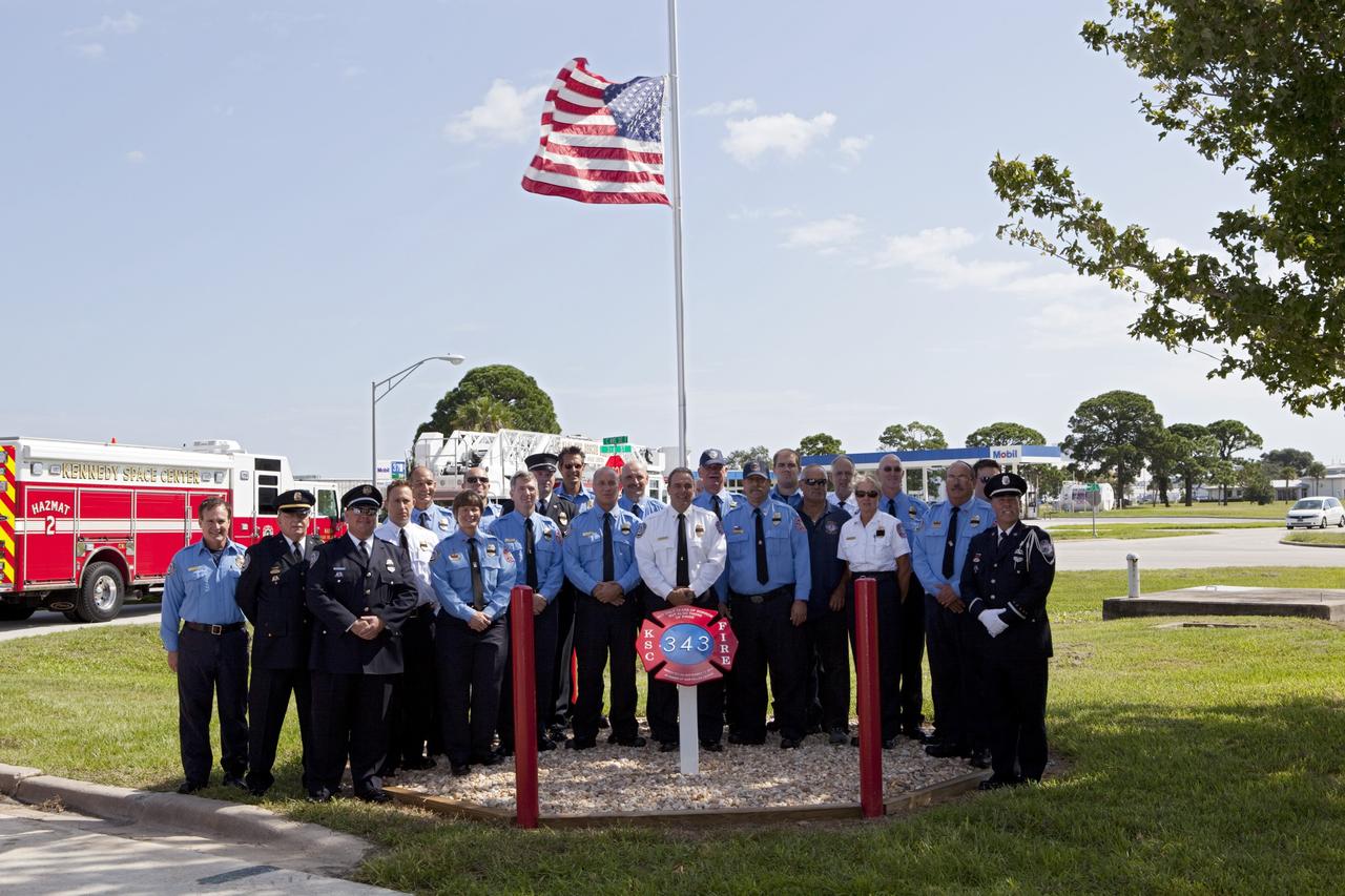CAPE CANAVERAL, Fla. – At Fire Station 1 at NASA’s Kennedy Space Center in Florida, Fire and Rescue personnel gathered near the new 9/11 memorial after the dedication ceremony.    Kennedy Fire and Rescue Services commemorated the 11th anniversary of 9/11 with a ceremony that included a minute of silence at 10:28 a.m., which was the moment of collapse of the north tower of the World Trade Center. Kennedy center-wide emergency units dispatched by Fire Control engaged in one-minute sirens, the new memorial was dedicated and the Honor Guard performed a flag-folding ceremony. Photo credit: NASA/Dimitri Gerondidakis