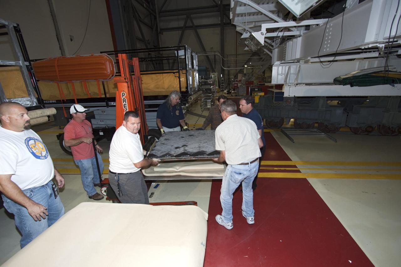 CAPE CANAVERAL, Fla. – In Bay 2 of the Orbiter Processing Facility at NASA's Kennedy Space Center in Florida, United Space Alliance technicians remove the two external fuel tank doors from the space shuttle Atlantis. Atlantis is undergoing final preparations for its transfer to the Kennedy Space Center Visitor Complex targeted for November. The work is part of Transition and Retirement of the remaining space shuttles, Atlantis and Endeavour. Atlantis is being prepared for public display at Kennedy's Visitor Complex. Over the course of its 26-year career, Atlantis spent 293 days in space during 33 missions. For more information, visit http://www.nasa.gov/transition Photo credit: NASA/Jim Grossmann