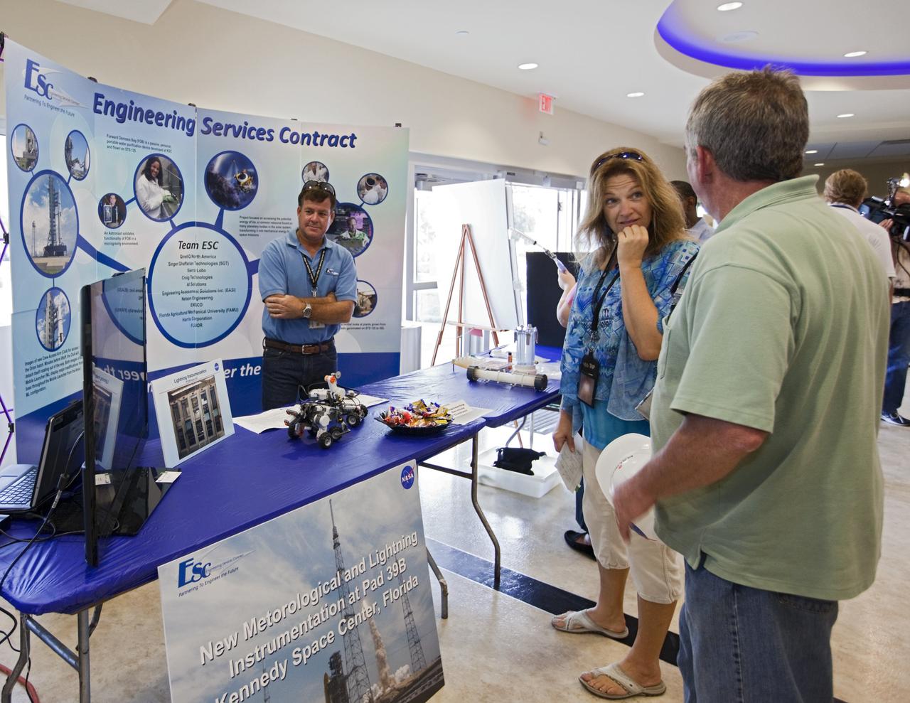 CAPE CANAVERAL, Fla. – At NASA’s Kennedy Space Center in Florida, workers visit several technology and innovation exhibits, including one by the Engineering Services Contract, in the lobby of the Operations and Checkout building during the center’s 2012 Innovation Expo.    The center-wide event gave researchers a chance to show some of their work to others at the center and gave employees the opportunity to see facilities they hadn’t seen before. Photo credit: NASA/Kim Shiflett