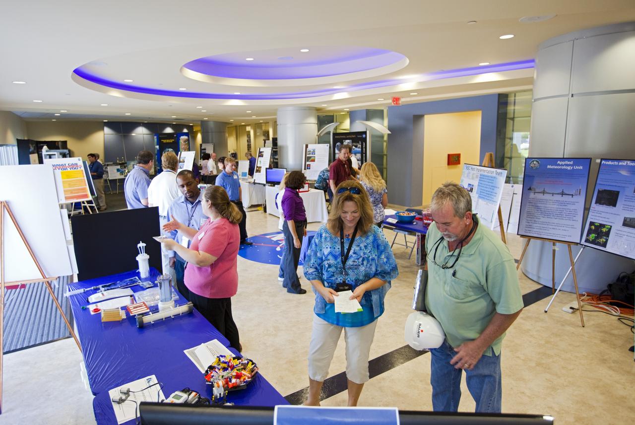 CAPE CANAVERAL, Fla. – At NASA’s Kennedy Space Center in Florida, workers visit several technology and innovation exhibits in the lobby of the Operations and Checkout building during the center’s 2012 Innovation Expo.    The center-wide event gave researchers a chance to show some of their work to others at the center and gave employees the opportunity to see facilities they hadn’t seen before. Photo credit: NASA/Kim Shiflett