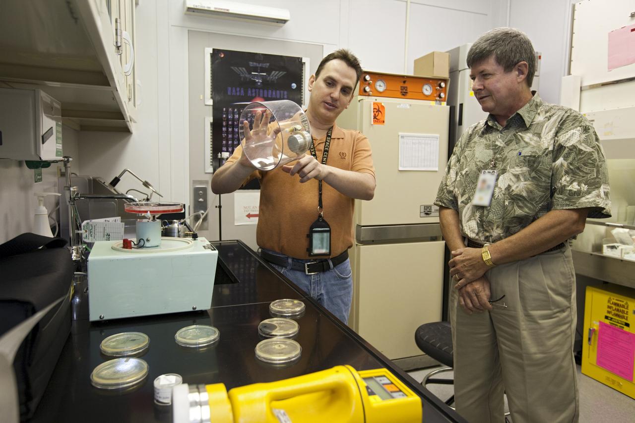 CAPE CANAVERAL, Fla. – In a laboratory at NASA’s Kennedy Space Center in Florida, a researcher describes the equipment he uses to run experiments to a fellow employee during the center’s 2012 Innovation Expo.    The center-wide event gave researchers a chance to show some of their work to others at the center and gave employees the opportunity to see facilities they hadn’t seen before. Photo credit: NASA/Kim Shiflett