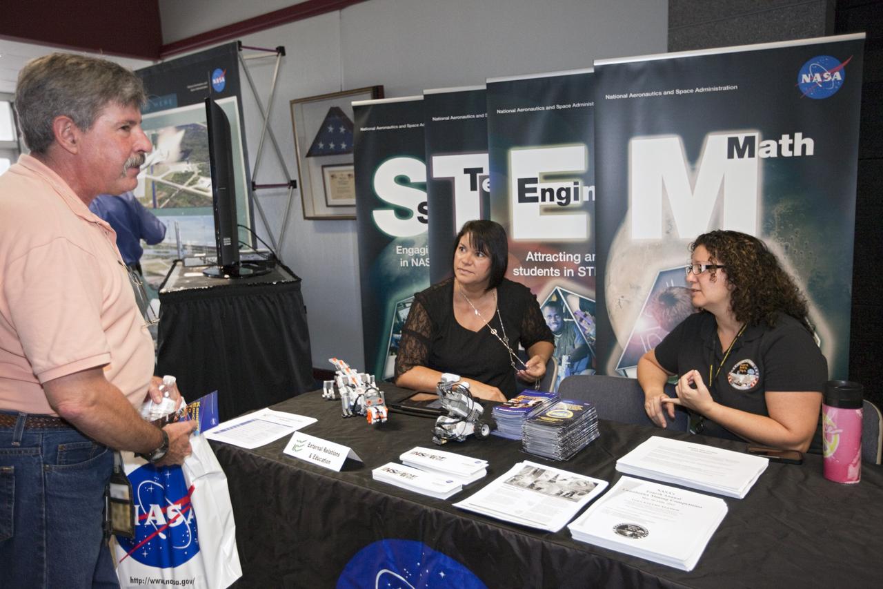 CAPE CANAVERAL, Fla. – At NASA’s Kennedy Space Center in Florida, a worker views an exhibit on education programs in the Headquarters lobby during the center’s 2012 Innovation Expo.    The center-wide event gave researchers a chance to show some of their work to others at the center and gave employees the opportunity to see facilities they hadn’t seen before. Photo credit: NASA/Kim Shiflett