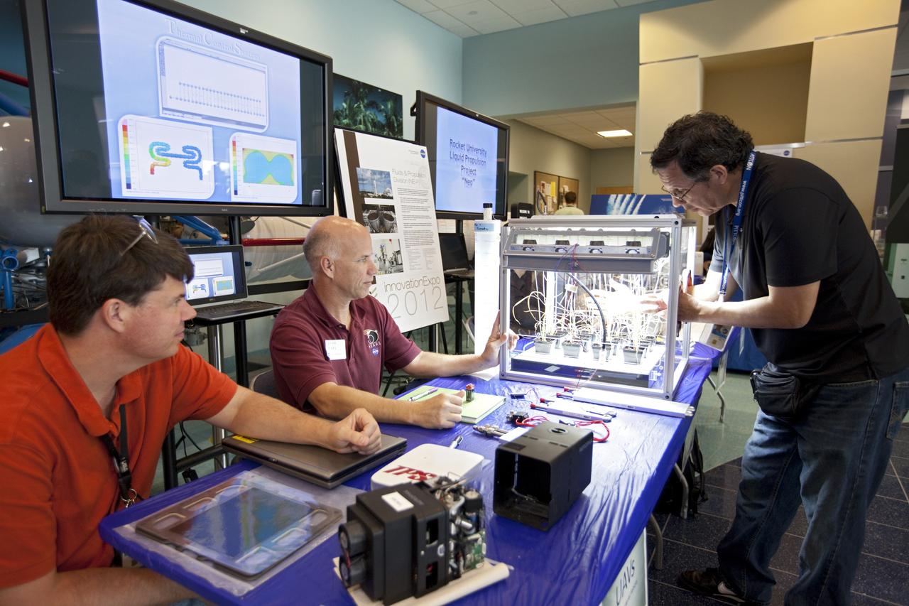CAPE CANAVERAL, Fla. – At NASA’s Kennedy Space Center in Florida, a worker gets hands-on experience with a plant experiment in the Operations and Support Building II during the center’s 2012 Innovation Expo.    The center-wide event gave researchers a chance to show some of their work to others at the center and gave employees the opportunity to see facilities they hadn’t seen before. Photo credit: NASA/Kim Shiflett