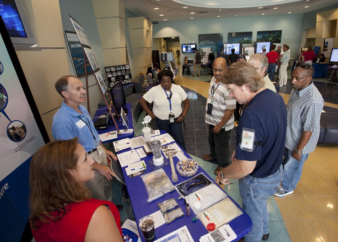 CAPE CANAVERAL, Fla. – At NASA’s Kennedy Space Center in Florida, workers view exhibits in the Operations and Support Building II lobby during the center’s 2012 Innovation Expo.    The center-wide event gave researchers a chance to show some of their work to others at the center and gave employees the opportunity to see facilities they hadn’t seen before. Photo credit: NASA/Kim Shiflett
